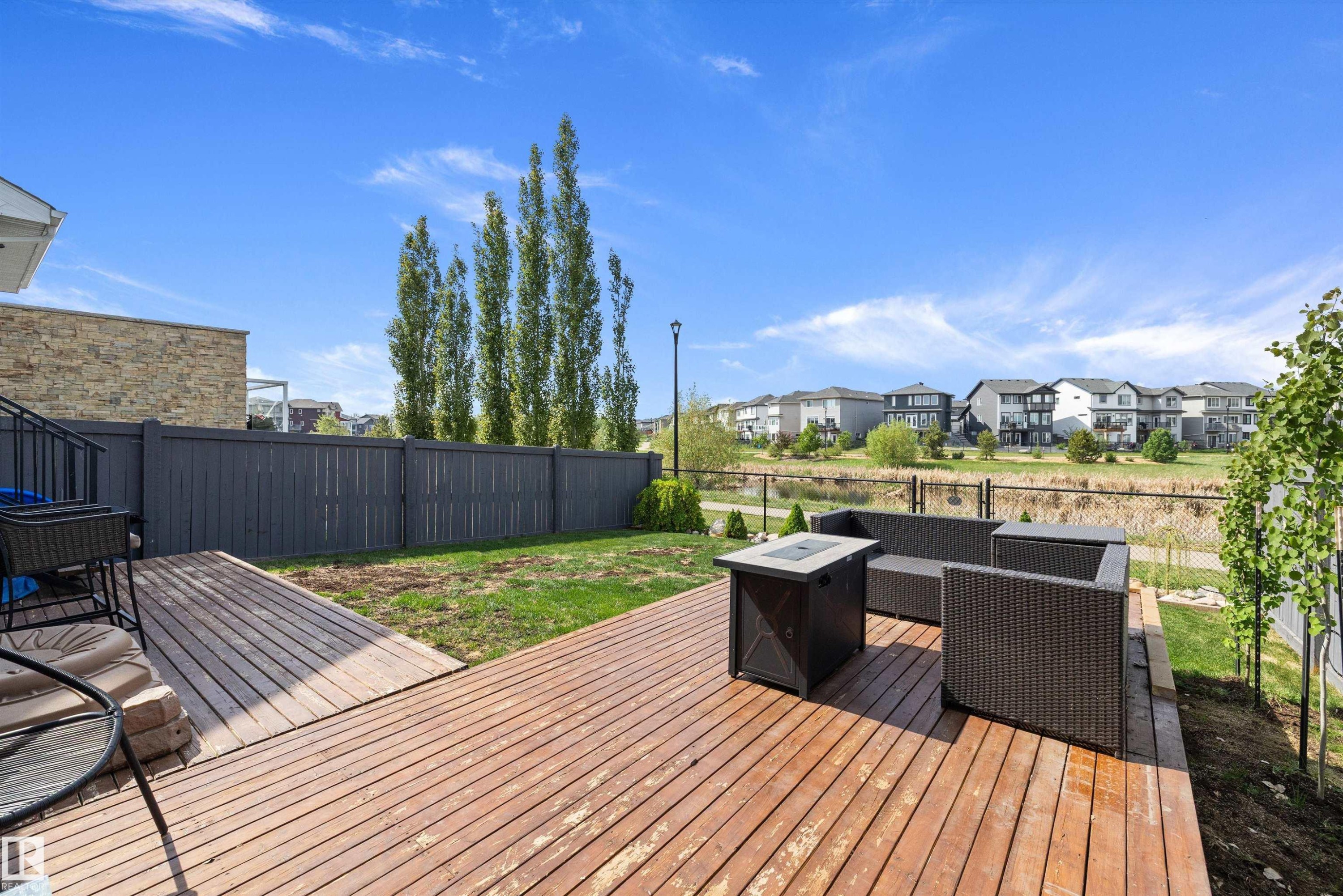 Expansive wood deck with a built-in fire pit, offering outdoor living space - 363 Cy Becker Boulevard, Edmonton, AB - Outdoor With Deck Patio Veranda