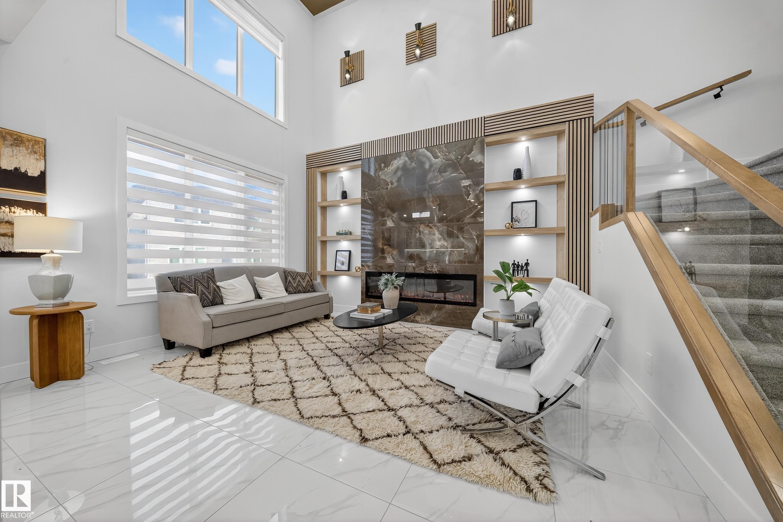 Two-story living area featuring a large window with privacy blinds, high ceilings, and light-toned tile flooring - 372 Creekside Green, Leduc, AB