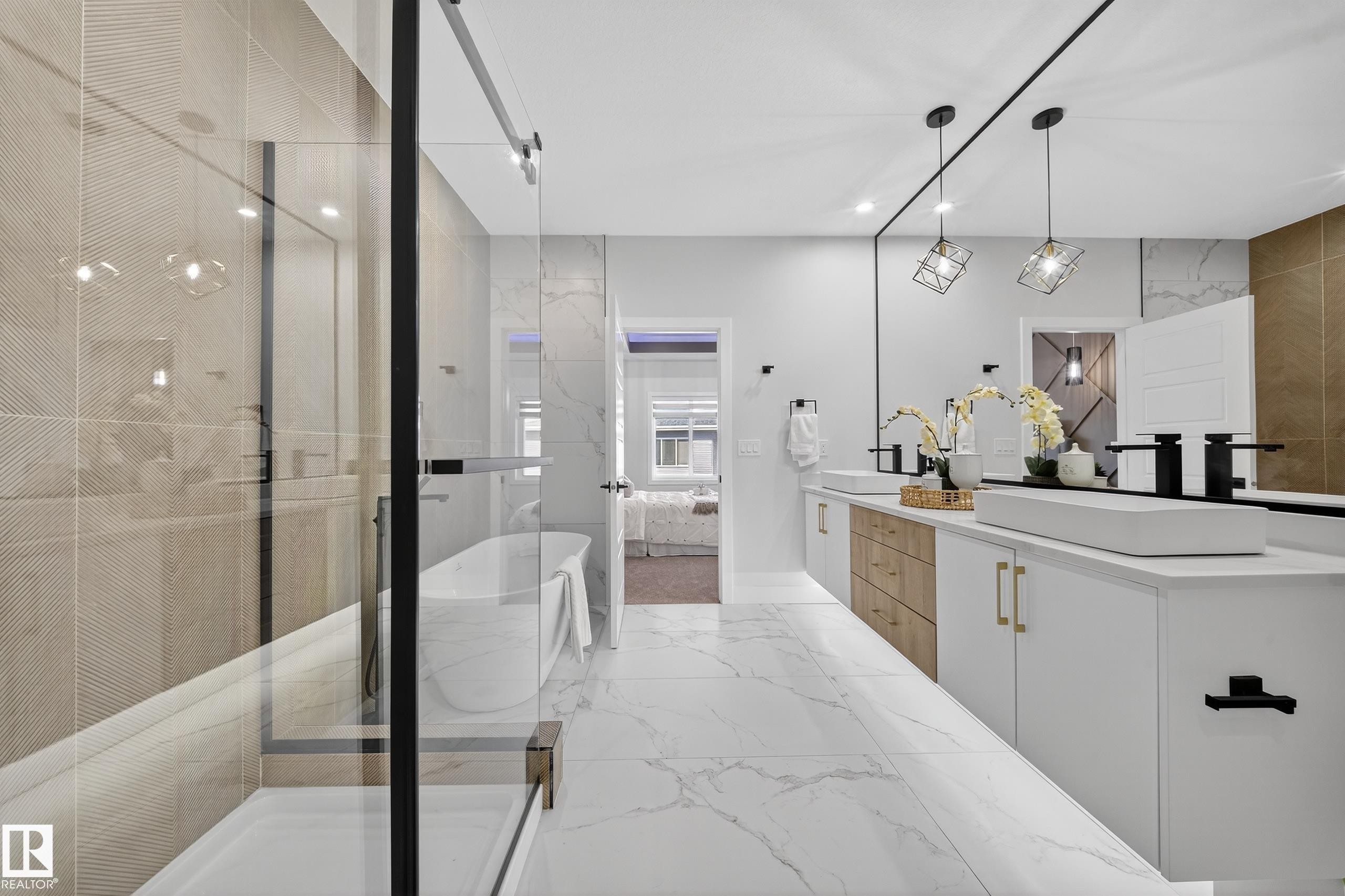 Contemporary bathroom featuring a spacious glass-enclosed shower, a freestanding soaking tub, a double vanity with vessel sinks, white and wood-finish cabinetry, and marble-look floor tiles - 372 Creekside Green, Leduc, AB