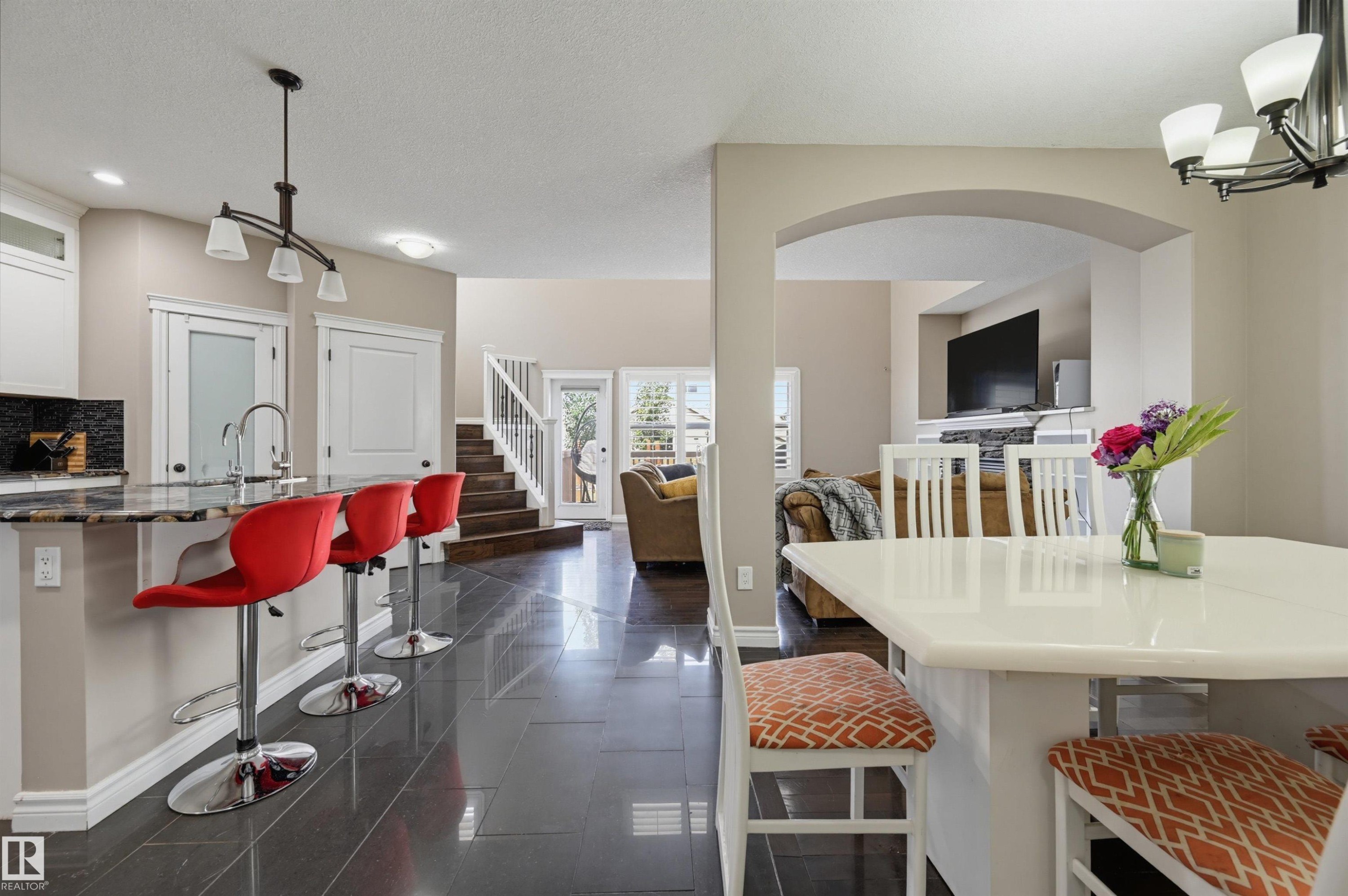 Open-concept living space with dark tile flooring - 21928 97 Avenue Nw, Edmonton, AB - Indoor