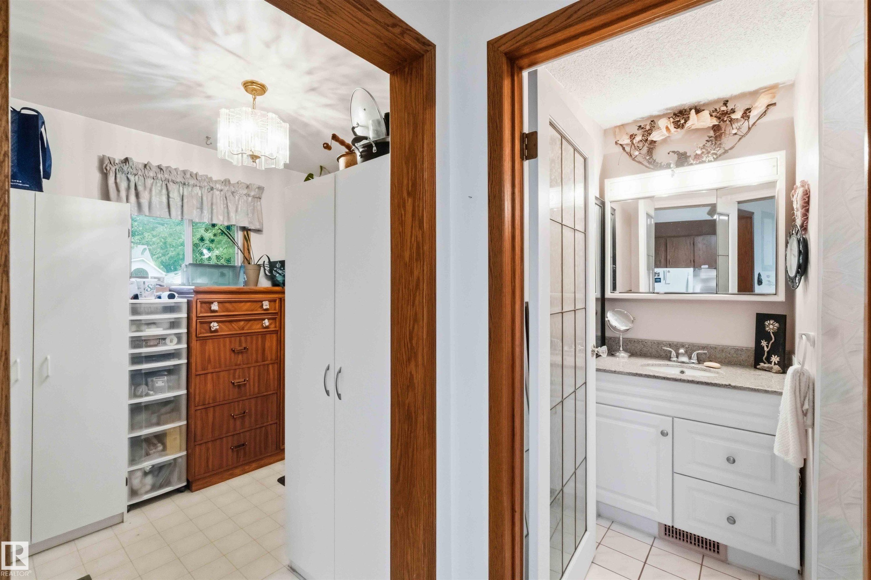 Bathroom featuring a vanity with white cabinetry, a light-colored countertop, and a mirrored medicine cabinet - 12016 61 Street, Edmonton, AB