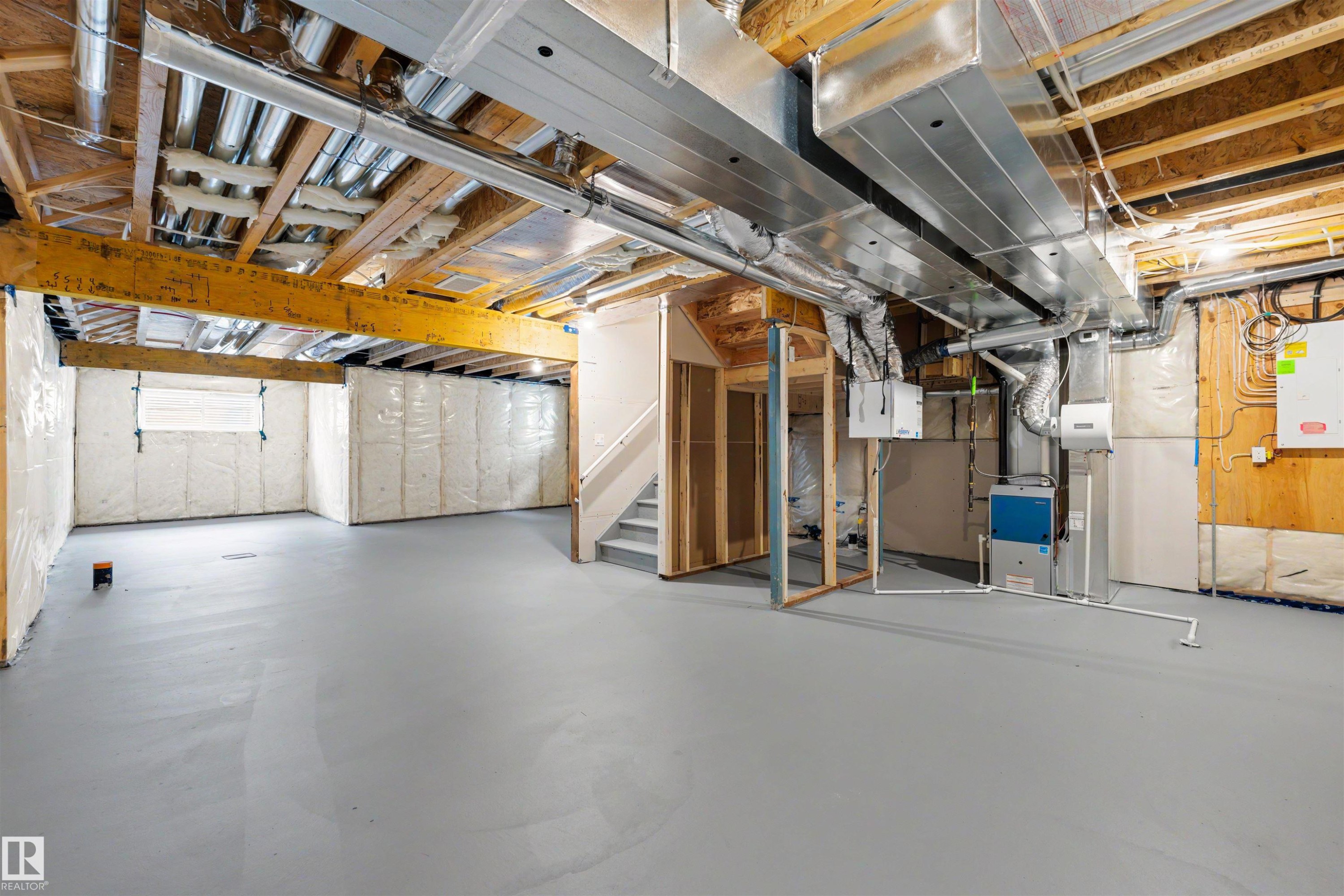 Unfinished basement space featuring a painted concrete floor and exposed wood ceiling joists - 24 Grayson Green, Stony Plain, AB