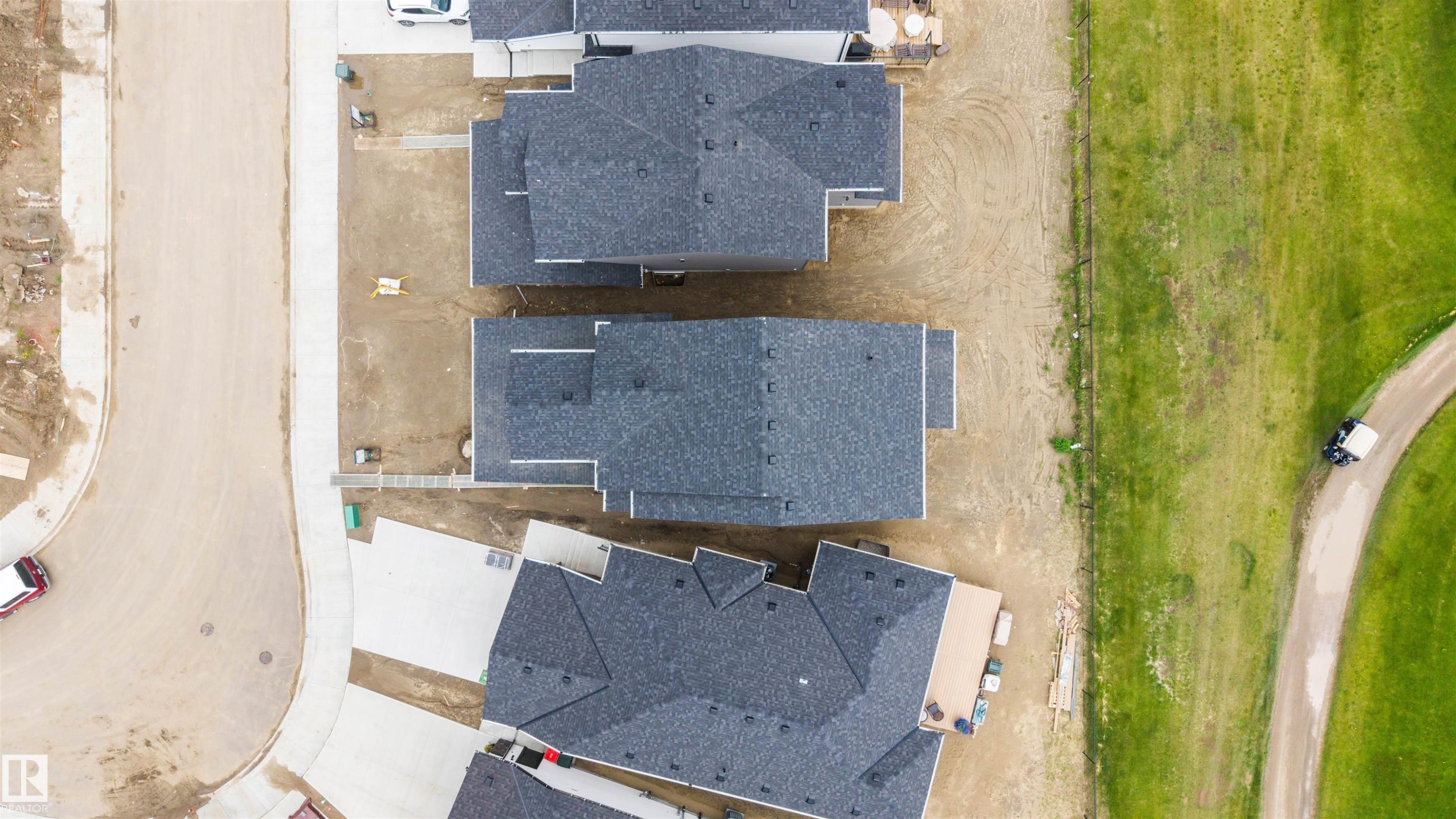 Aerial perspective showcasing properties with dark asphalt shingle roofing - 24 Grayson Green, Stony Plain, AB
