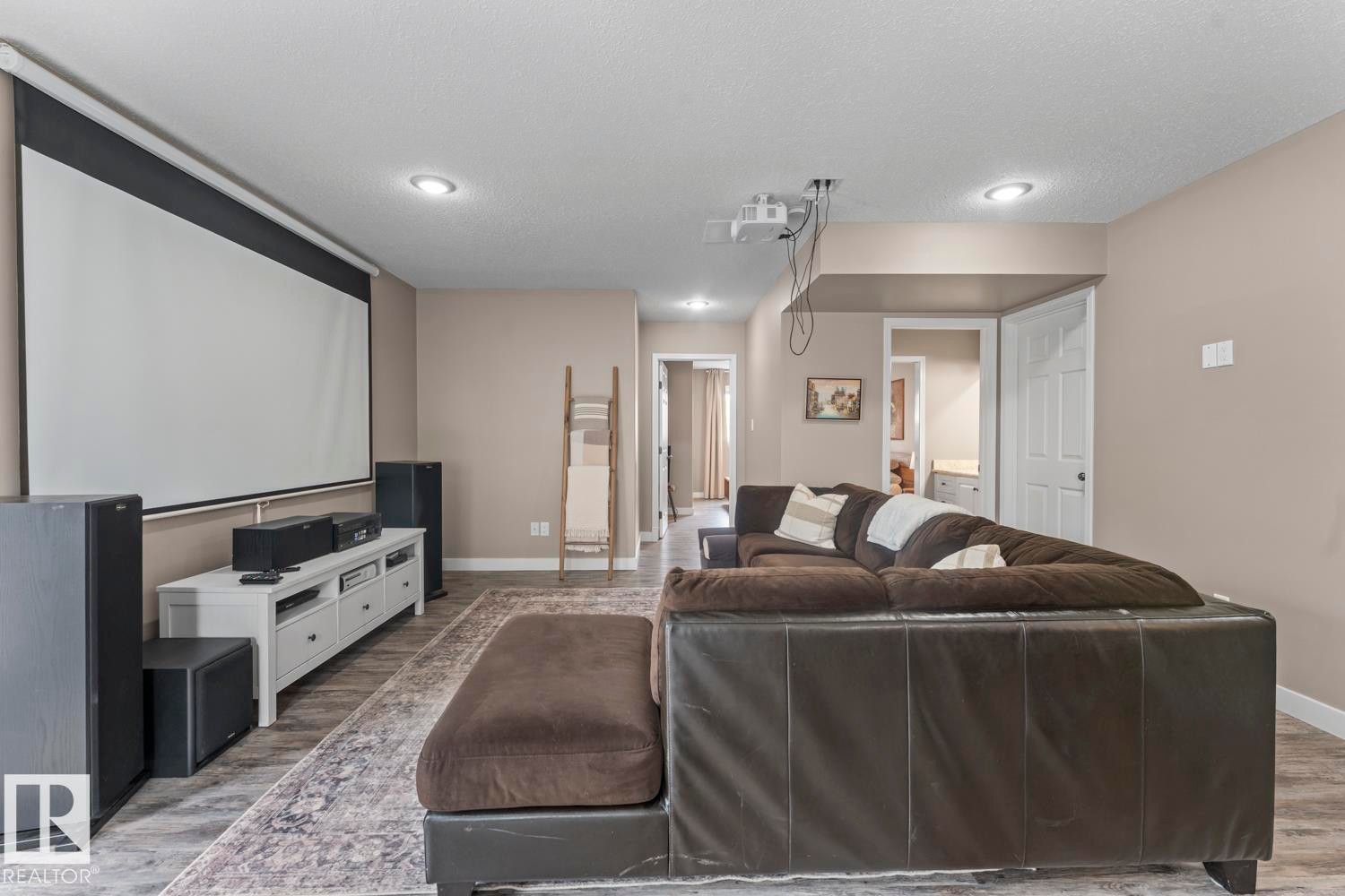 Entertainment space featuring a retractable projector screen and overhead projector - 2602 Delta Road, Cold Lake, AB