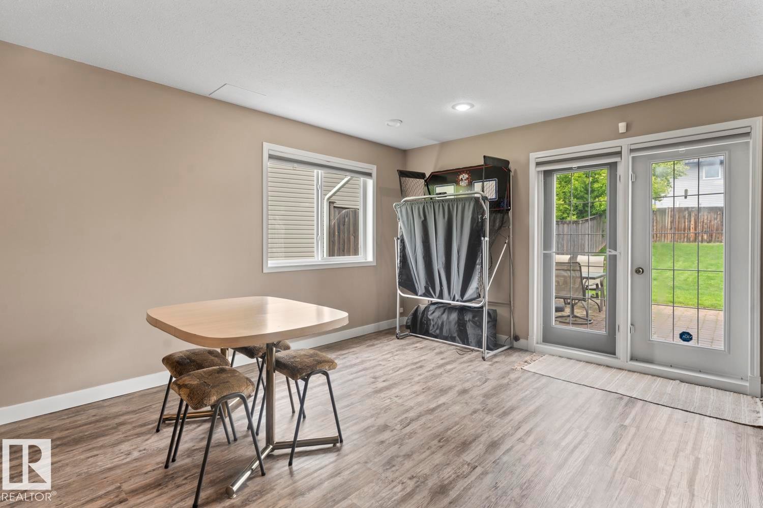 Spacious room featuring wood-finish flooring, recessed lighting, and neutral wall tones - 2602 Delta Road, Cold Lake, AB