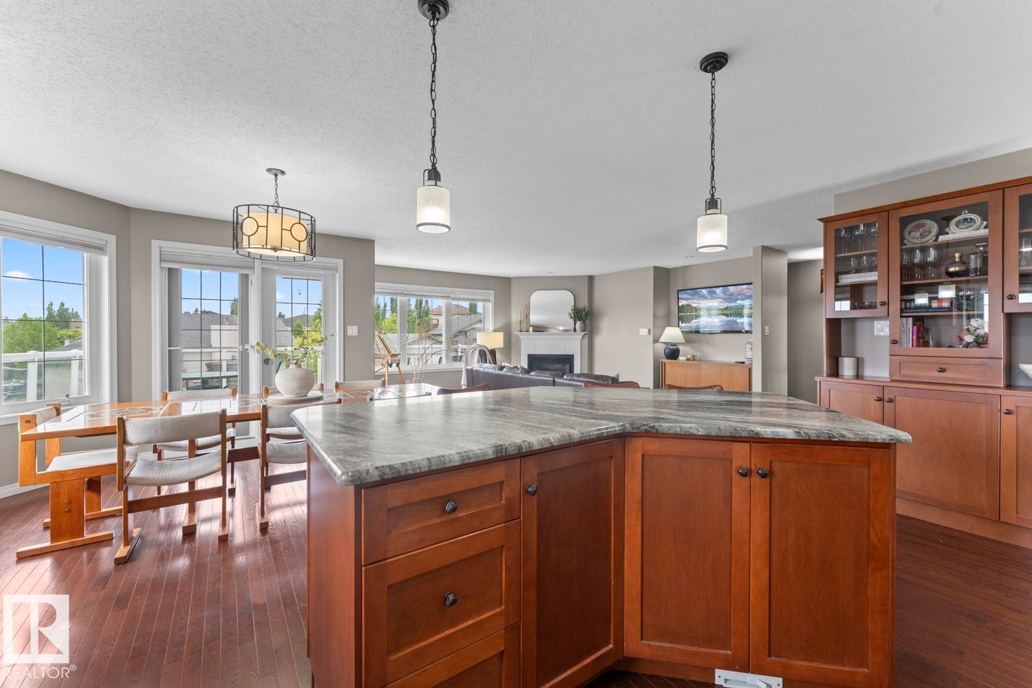 Kitchen island featuring a stone countertop and wood cabinetry - 2602 Delta Road, Cold Lake, AB