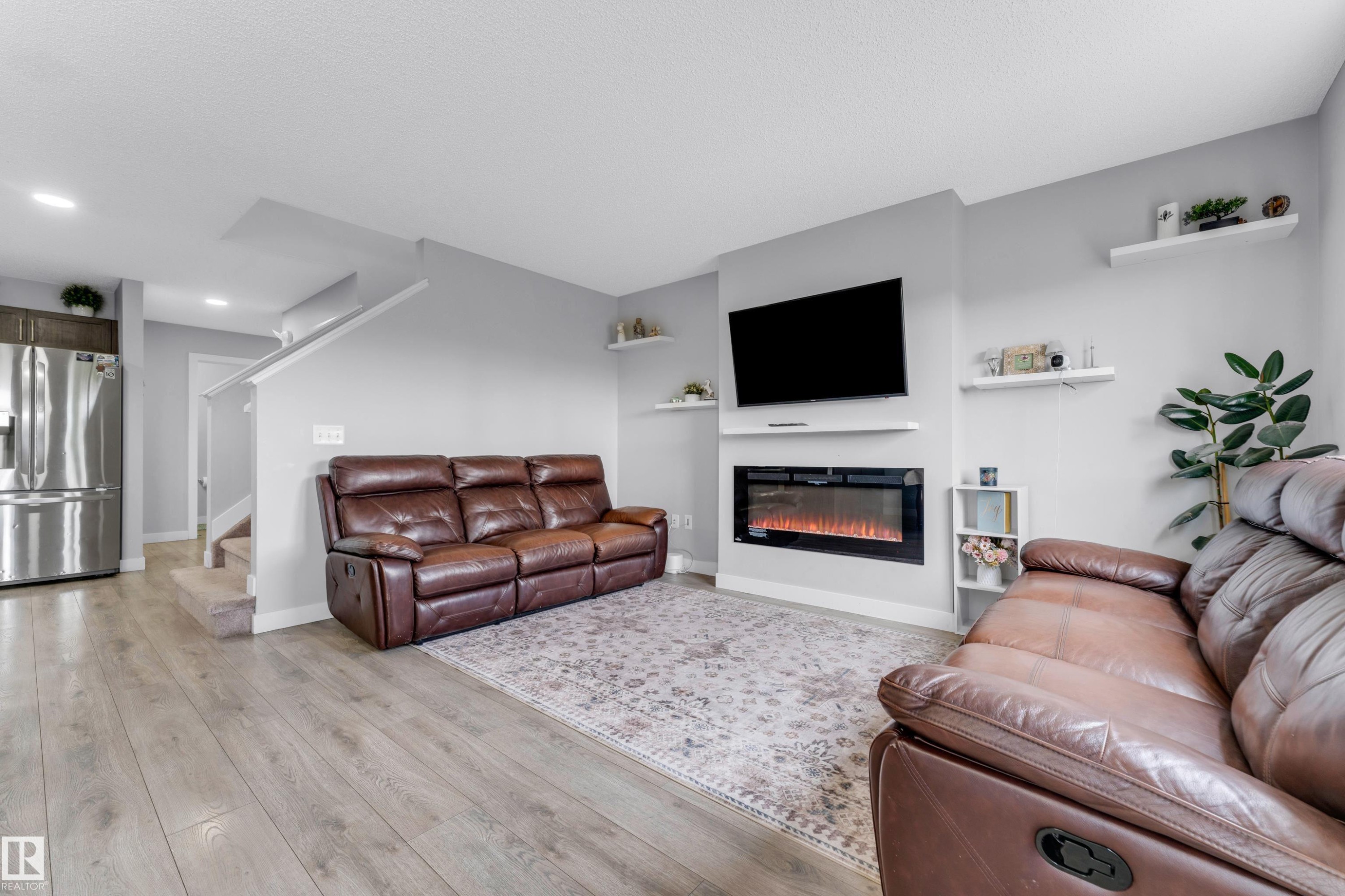 Living area with wood-finish flooring and light gray walls - 1750 27 Street, Edmonton, AB