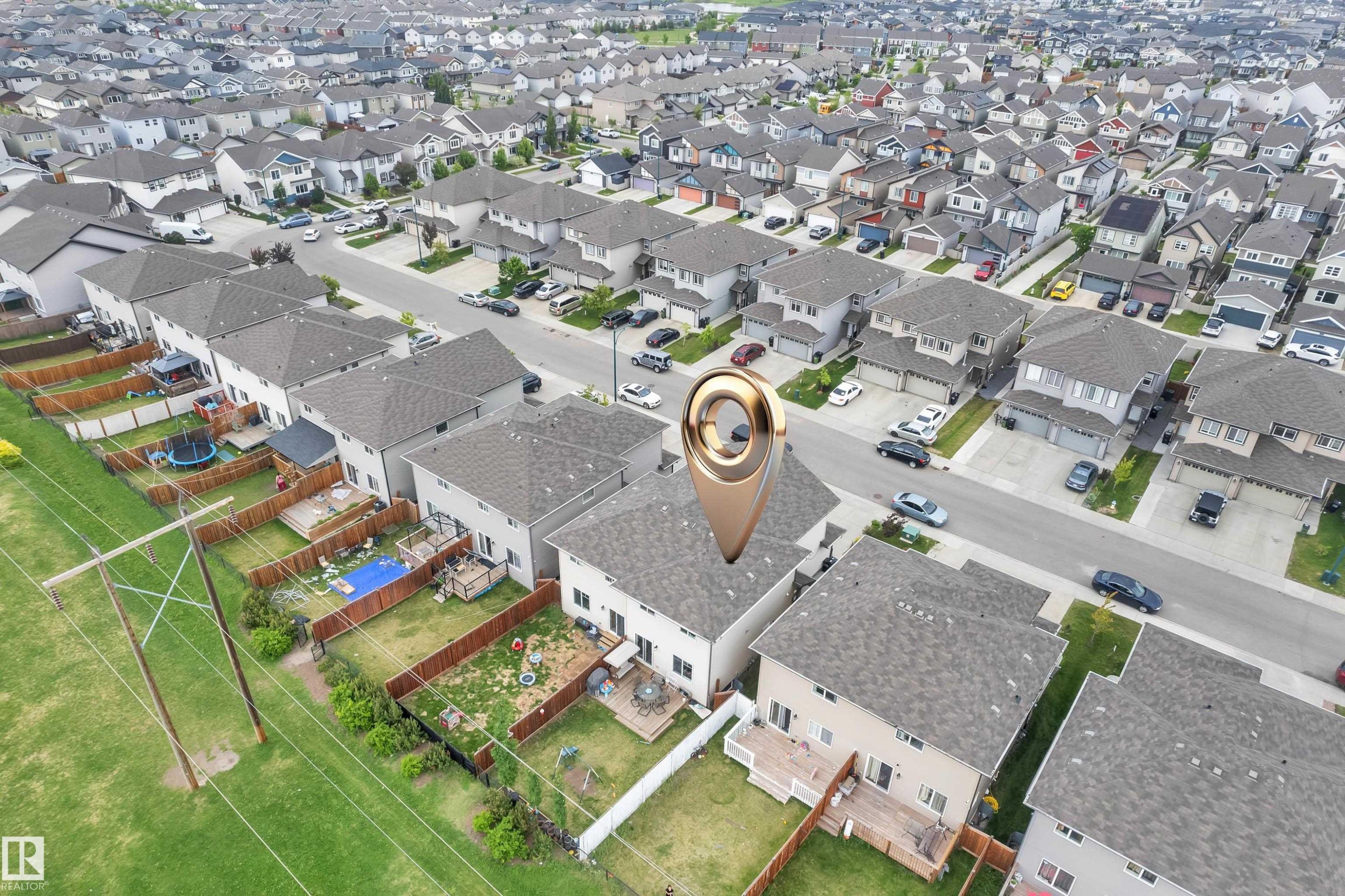 Aerial view of a residential community featuring numerous single-family homes with gray shingle roofs - 1750 27 Street, Edmonton, AB