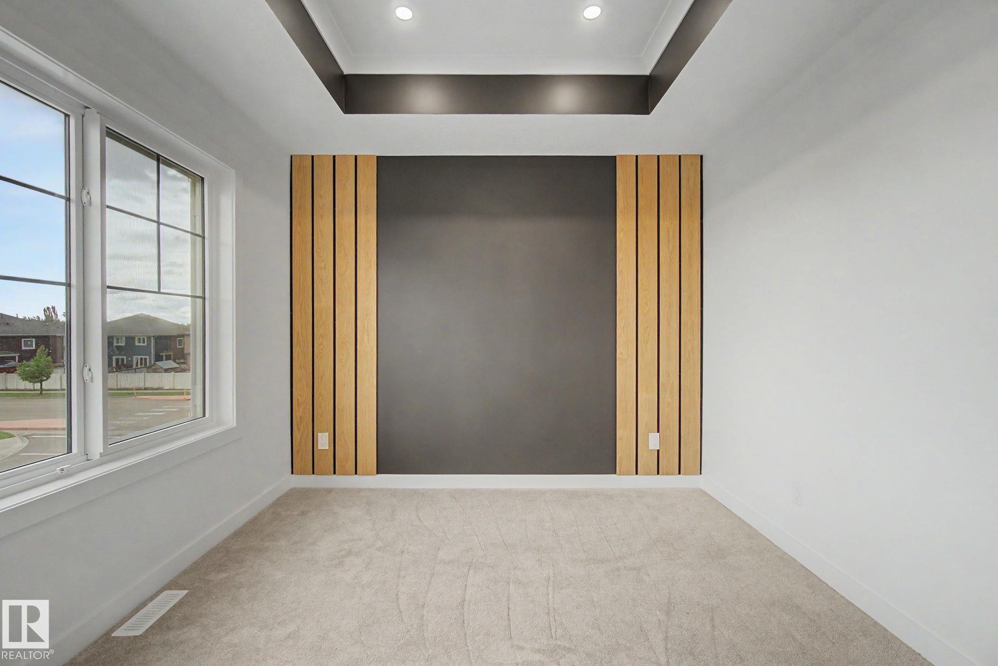 Accent wall featuring vertical wood paneling and a dark central panel - 4 Willow Heights Drive, Stony Plain, AB