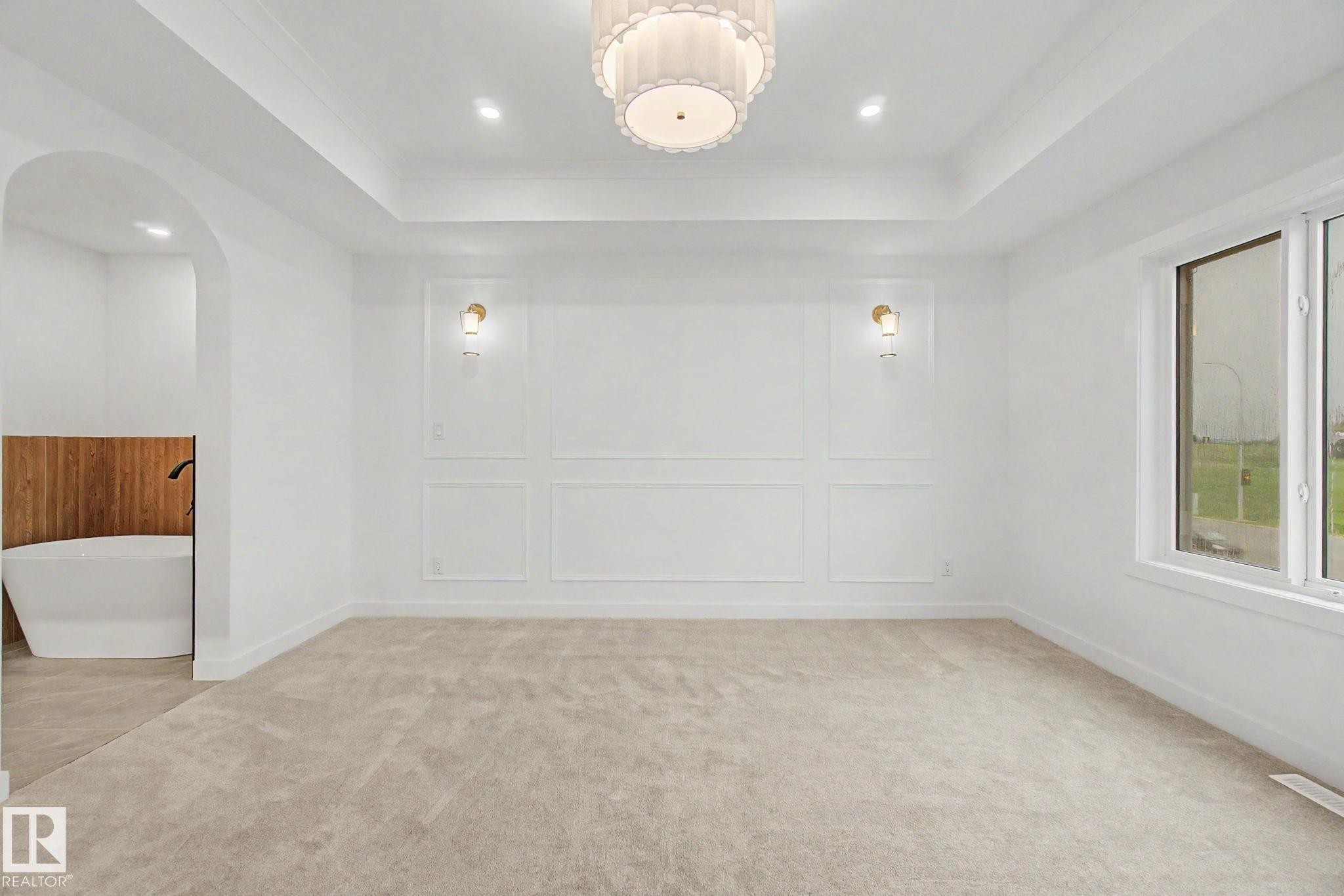 Recessed ceiling with an ornate semi-flush mount light fixture and additional recessed lighting - 4 Willow Heights Drive, Stony Plain, AB