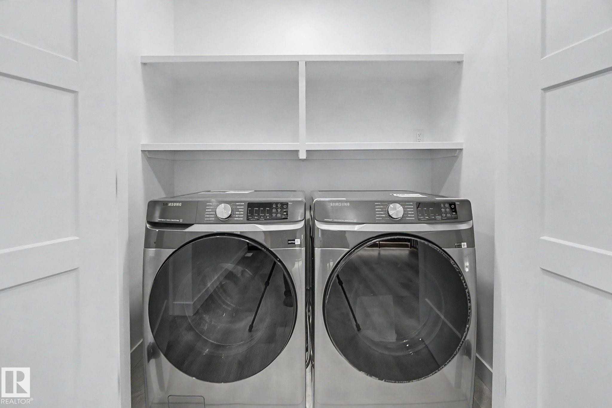 Dedicated laundry area featuring a front-loading washer and dryer set - 4 Willow Heights Drive, Stony Plain, AB