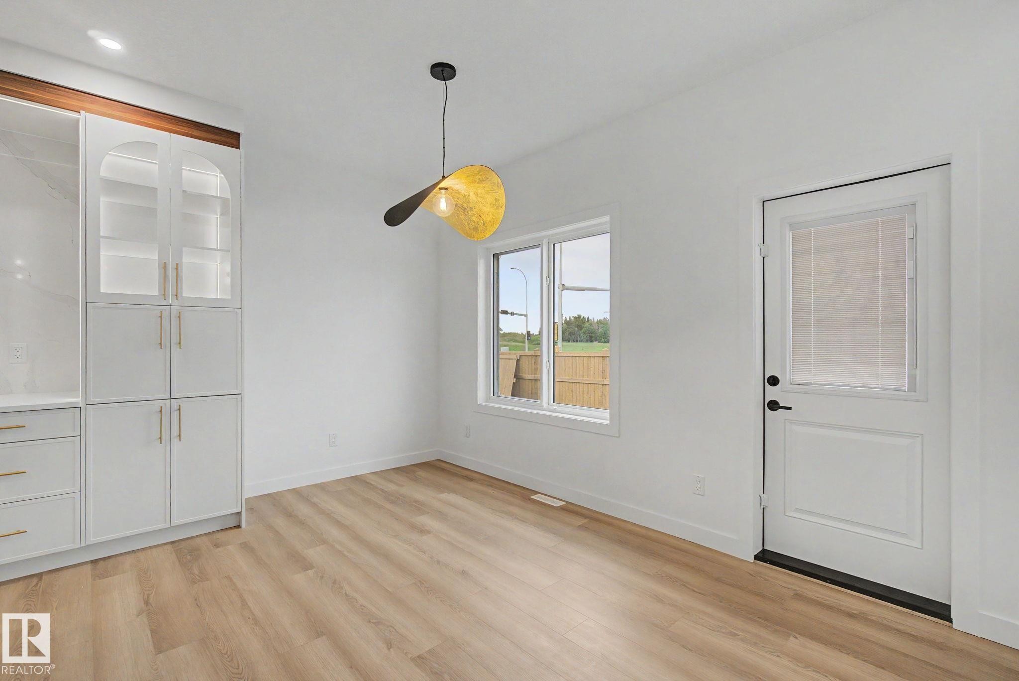 Bright room featuring wood-finish flooring and white walls - 4 Willow Heights Drive, Stony Plain, AB