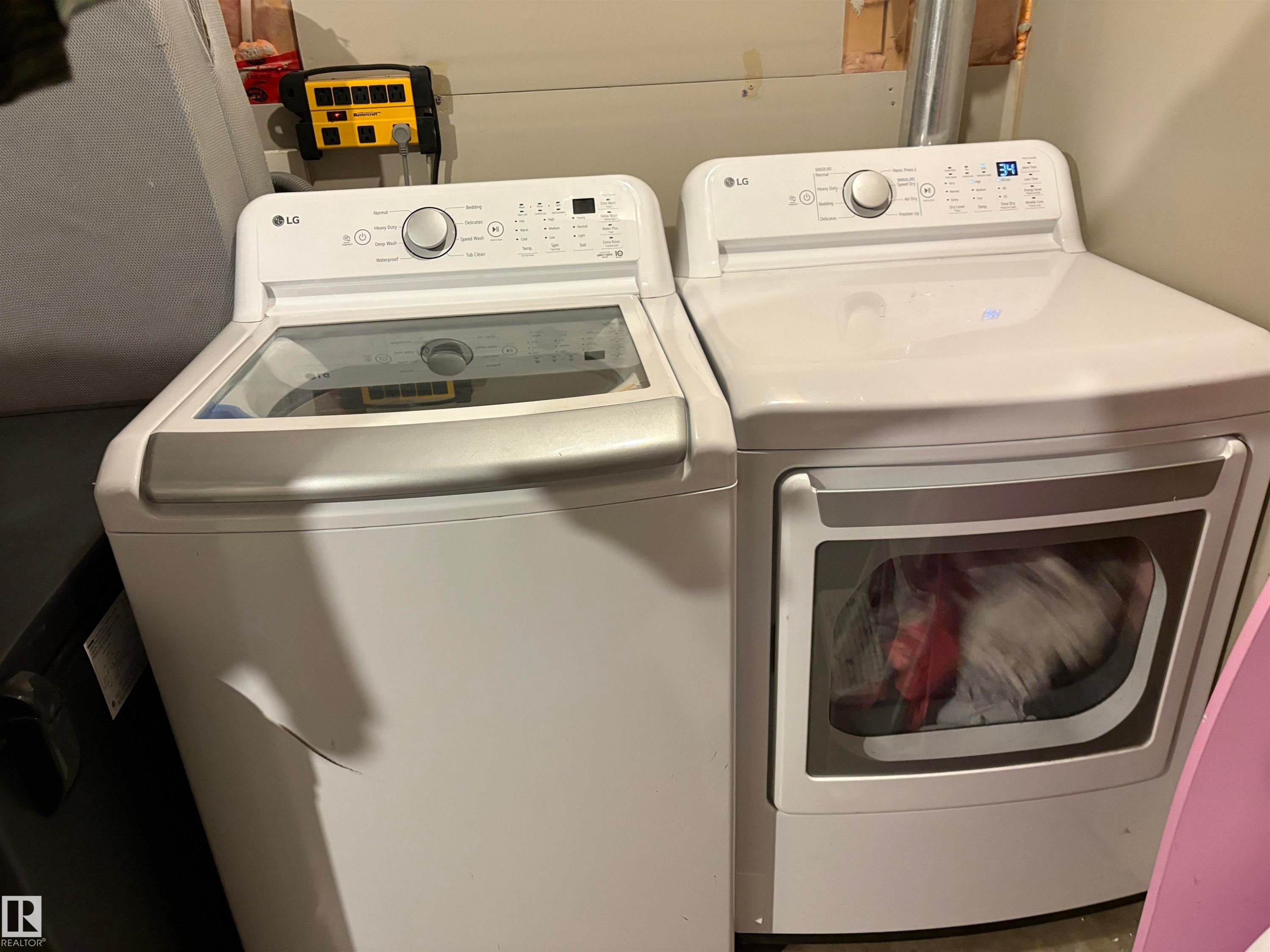White top-load washer and front-load dryer set, featuring digital controls and a clear washer lid - 184 1804 70 Street, Edmonton, AB
