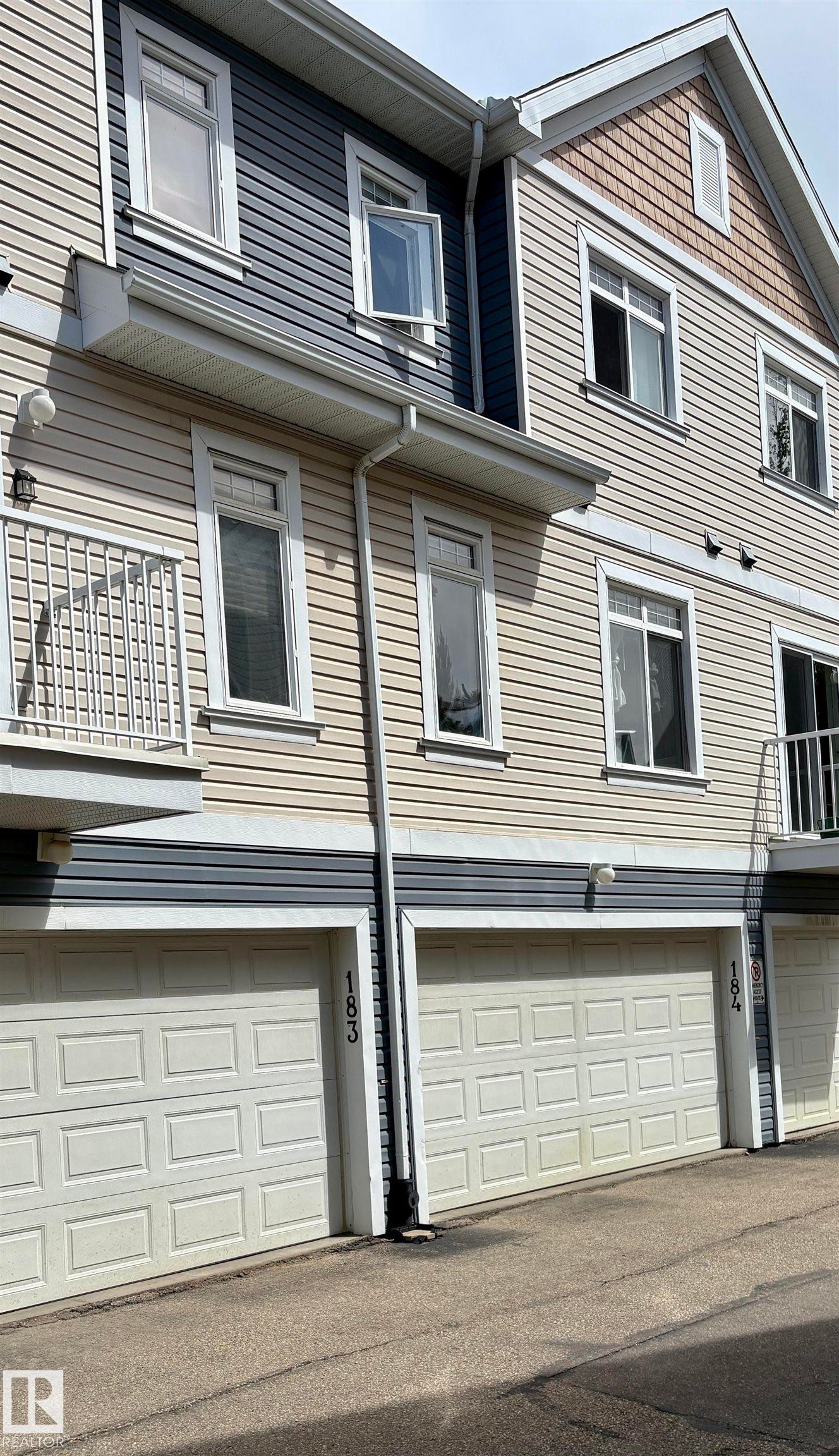 Multi-level townhouse exterior featuring horizontal siding and decorative shingles - 184 1804 70 Street, Edmonton, AB