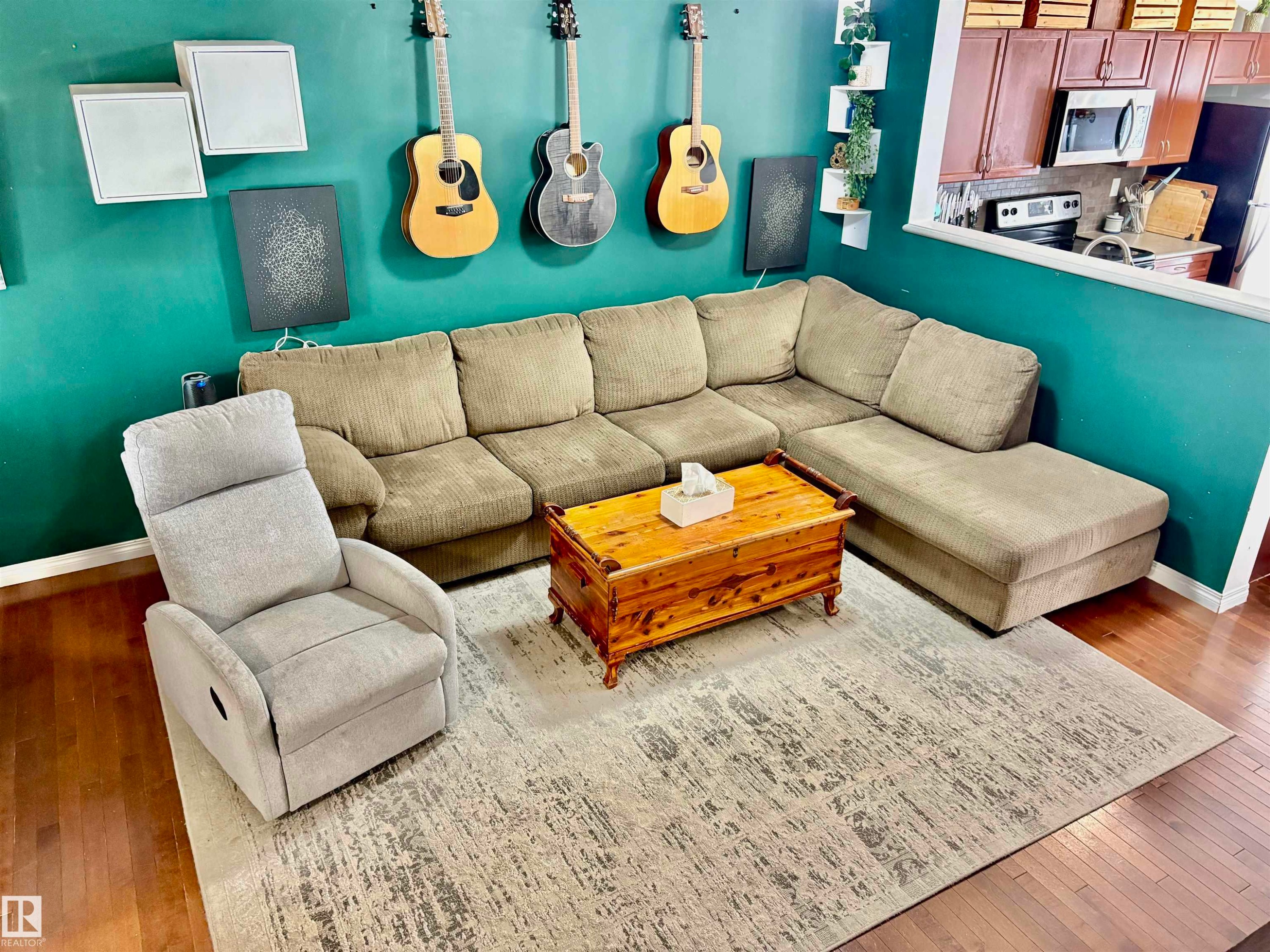 Hardwood-style flooring throughout the living area - 184 1804 70 Street, Edmonton, AB