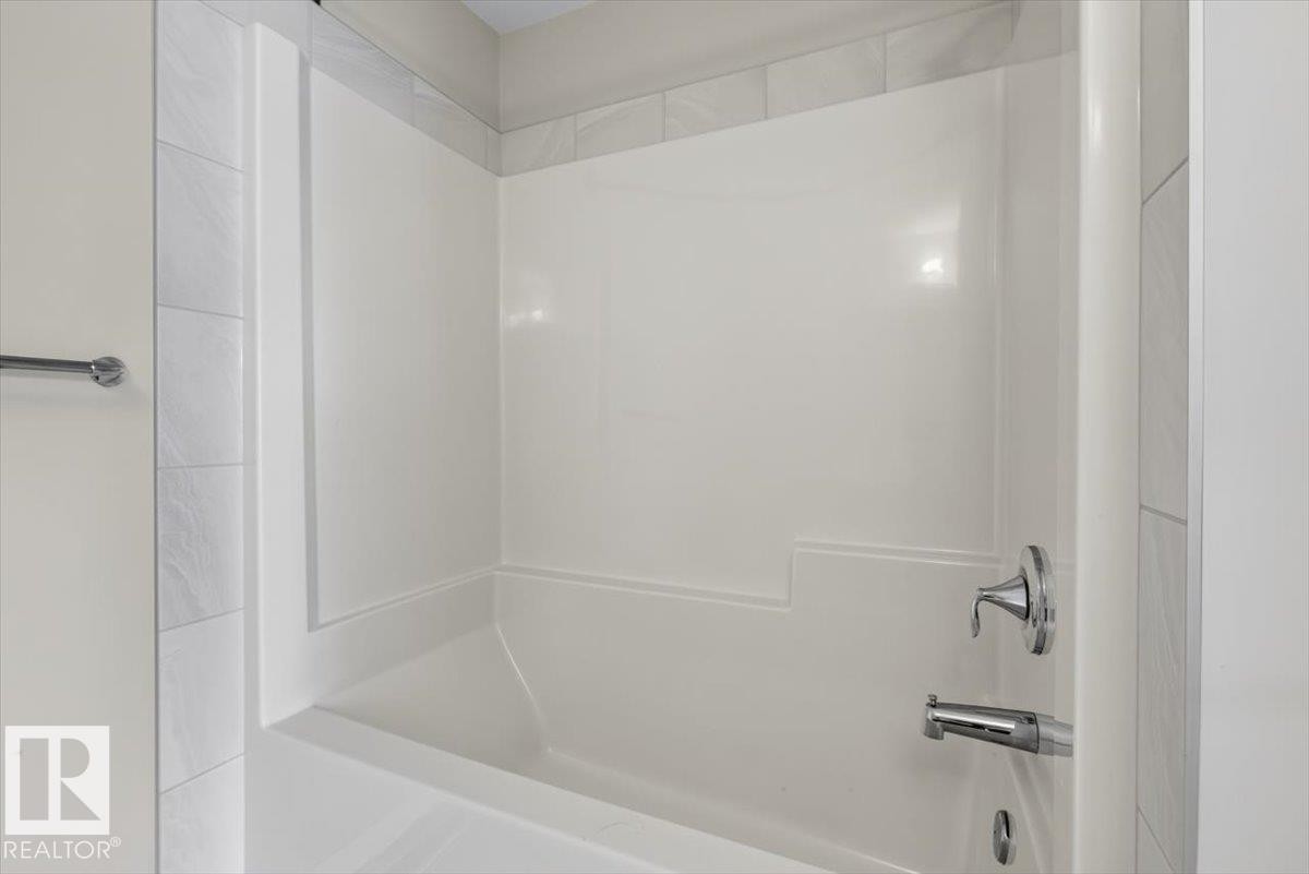 White fiberglass tub and shower combination with chrome fixtures - 2144 51 Street, Edmonton, AB