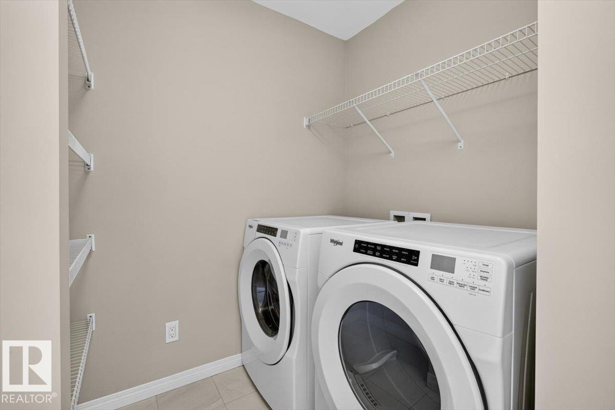Dedicated laundry area with tile flooring and neutral wall tones - 2144 51 Street, Edmonton, AB