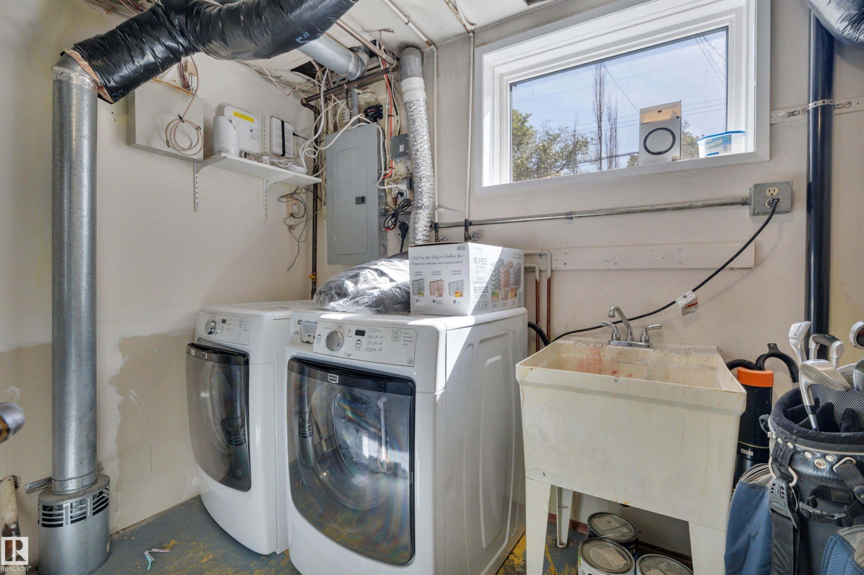 Utility room featuring a window, laundry hookups, and a utility sink - 9835 74 Street, Edmonton, AB