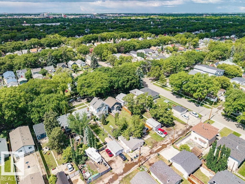 Aerial perspective showcasing a residential neighborhood with mature tree coverage - 11241 88 Street, Edmonton, AB