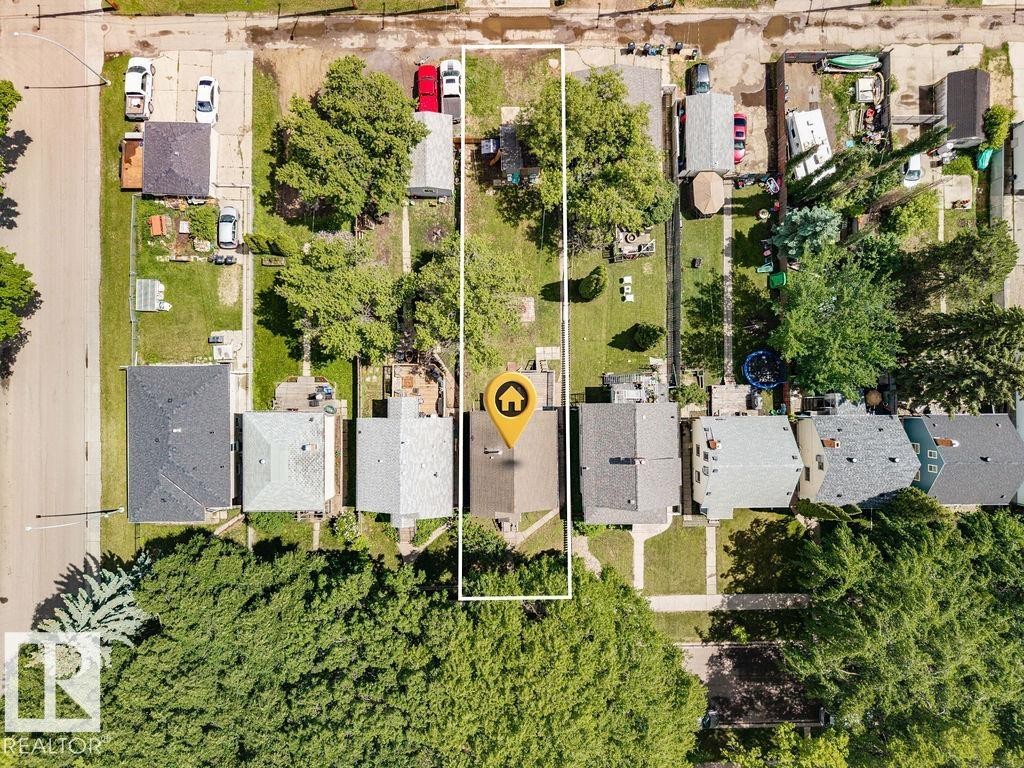 Residential property featuring a rectangular lot, mature trees, and a detached structure - 11241 88 Street, Edmonton, AB