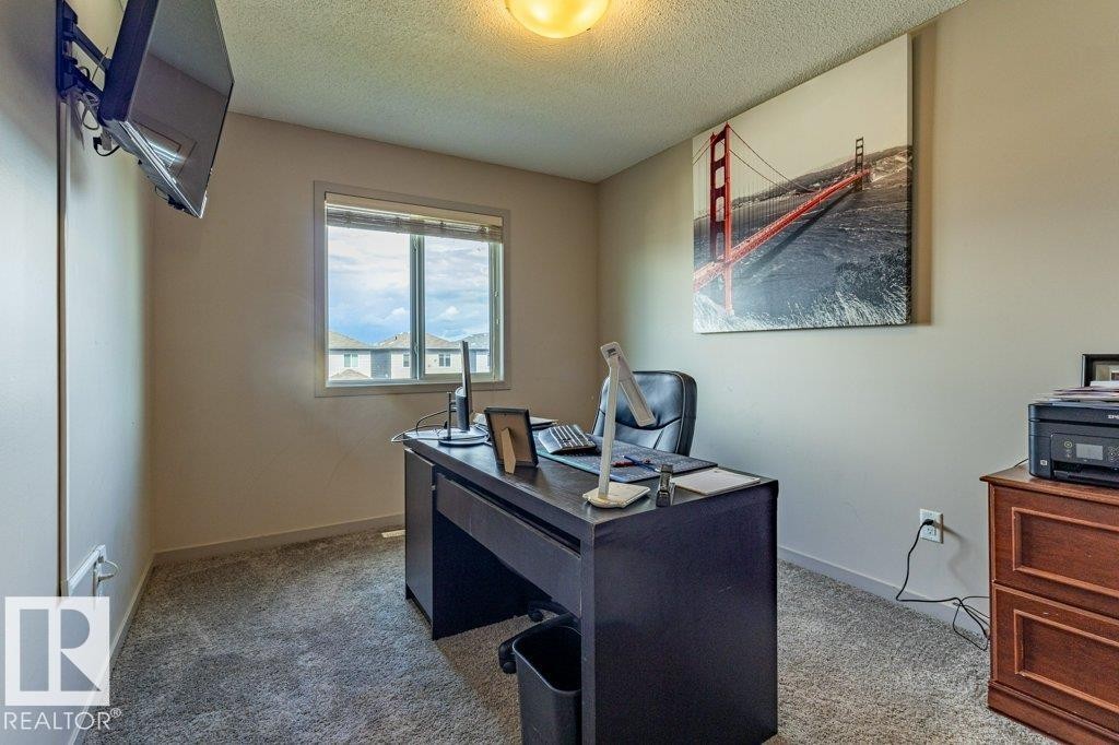 Carpeted room with a window providing exterior views - 17123 49 Street, Edmonton, AB