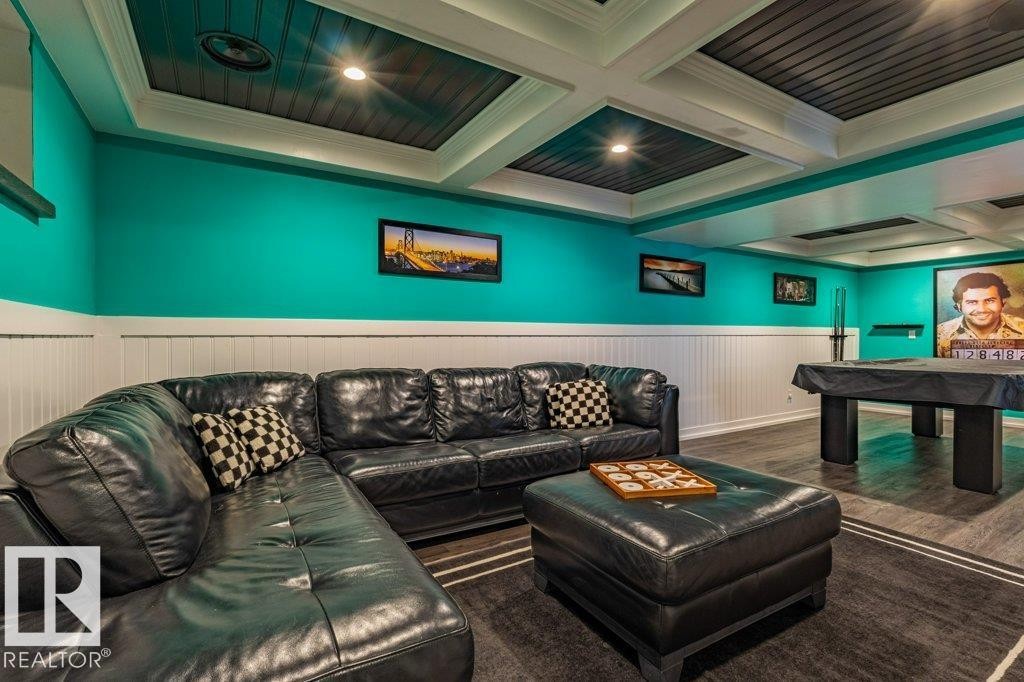 Recreation room featuring white wainscoting, teal walls, recessed lighting, and a coffered ceiling with dark wood-finish inserts - 17123 49 Street, Edmonton, AB