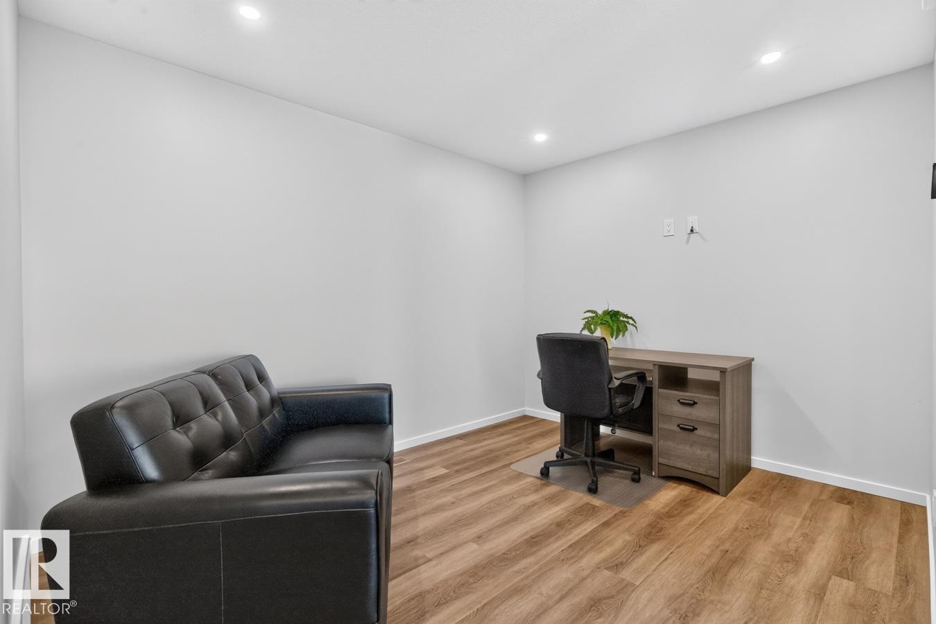 Room featuring recessed lighting, light gray walls, wood-finish flooring, and white baseboards - 1022 Hearthstone Boulevard, Sherwood Park, AB