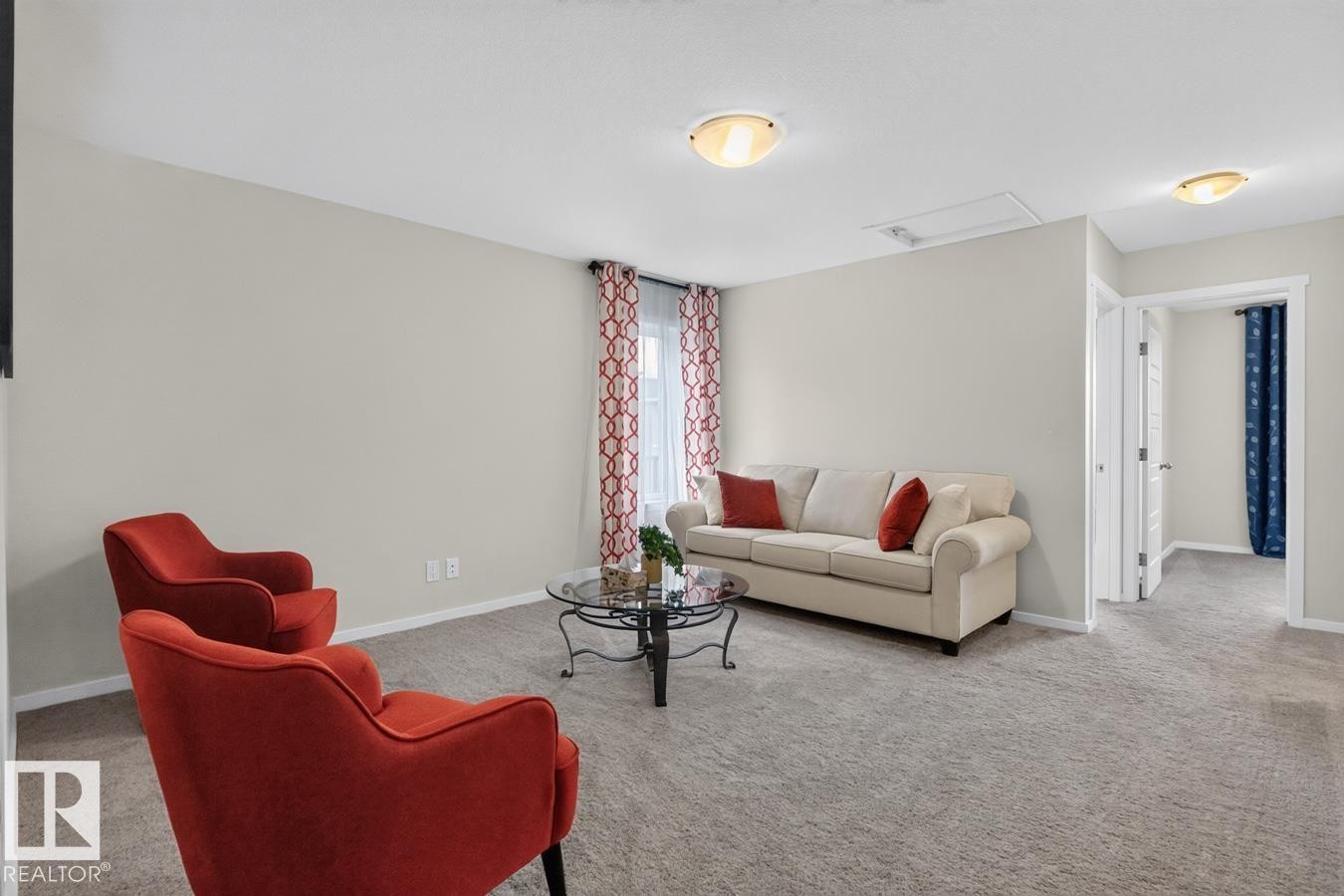 Open concept room featuring neutral tone walls, light gray carpeting, and white trim - 1022 Hearthstone Boulevard, Sherwood Park, AB