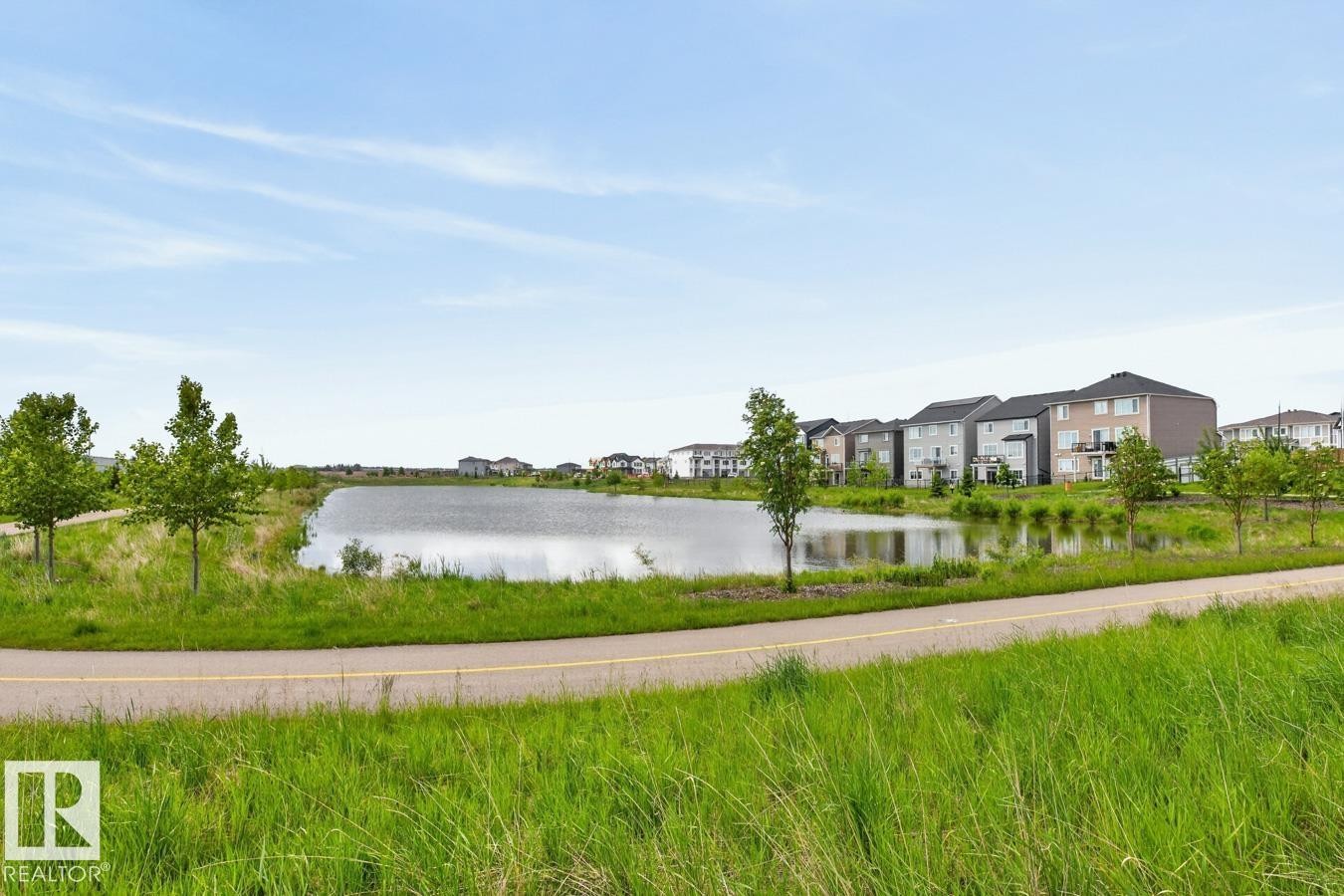Pond-front properties featuring varied architectural styles and private balconies - 1022 Hearthstone Boulevard, Sherwood Park, AB