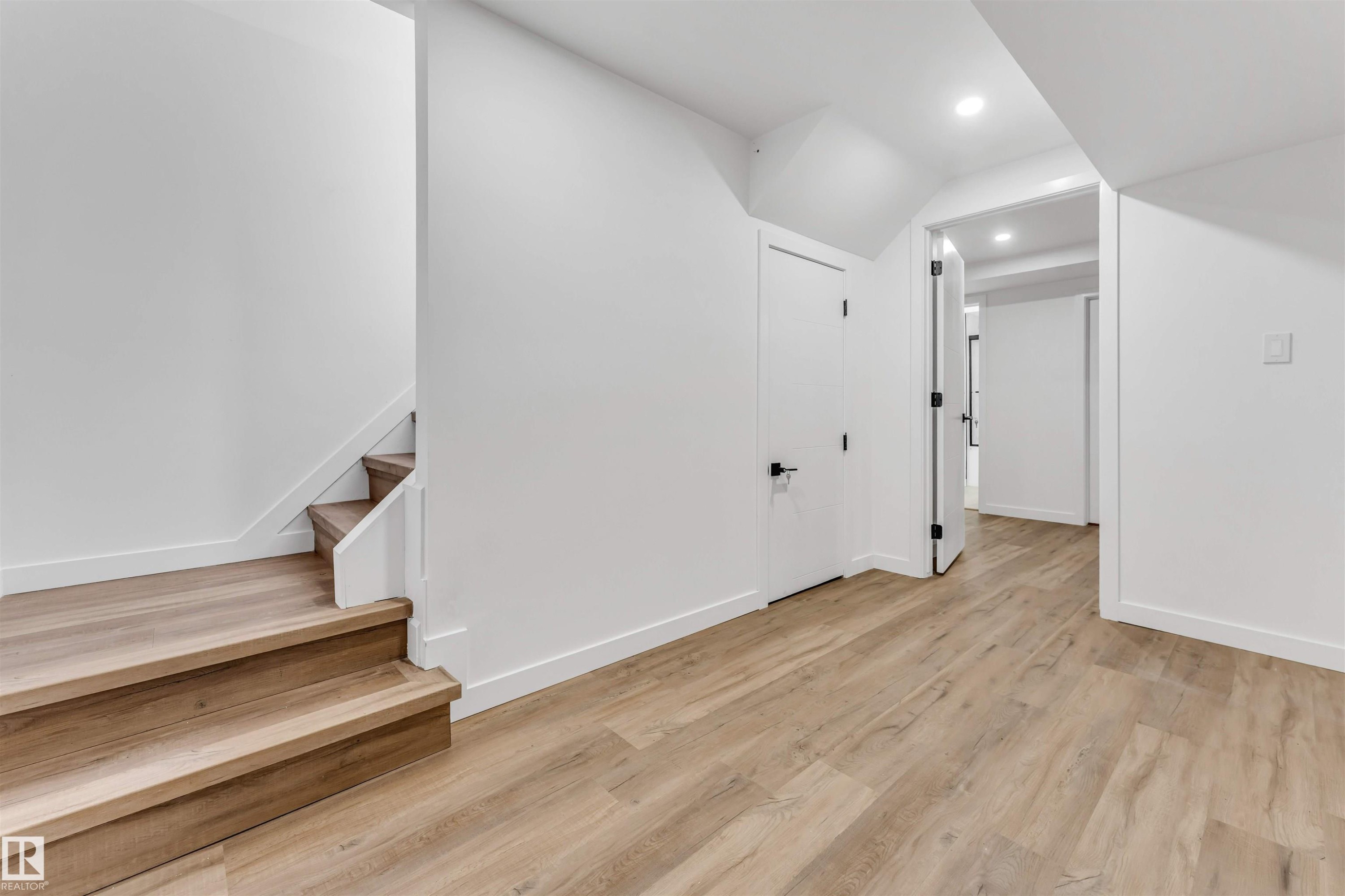Spacious interior with light wood-finish flooring - 6404 88 Avenue, Edmonton, AB