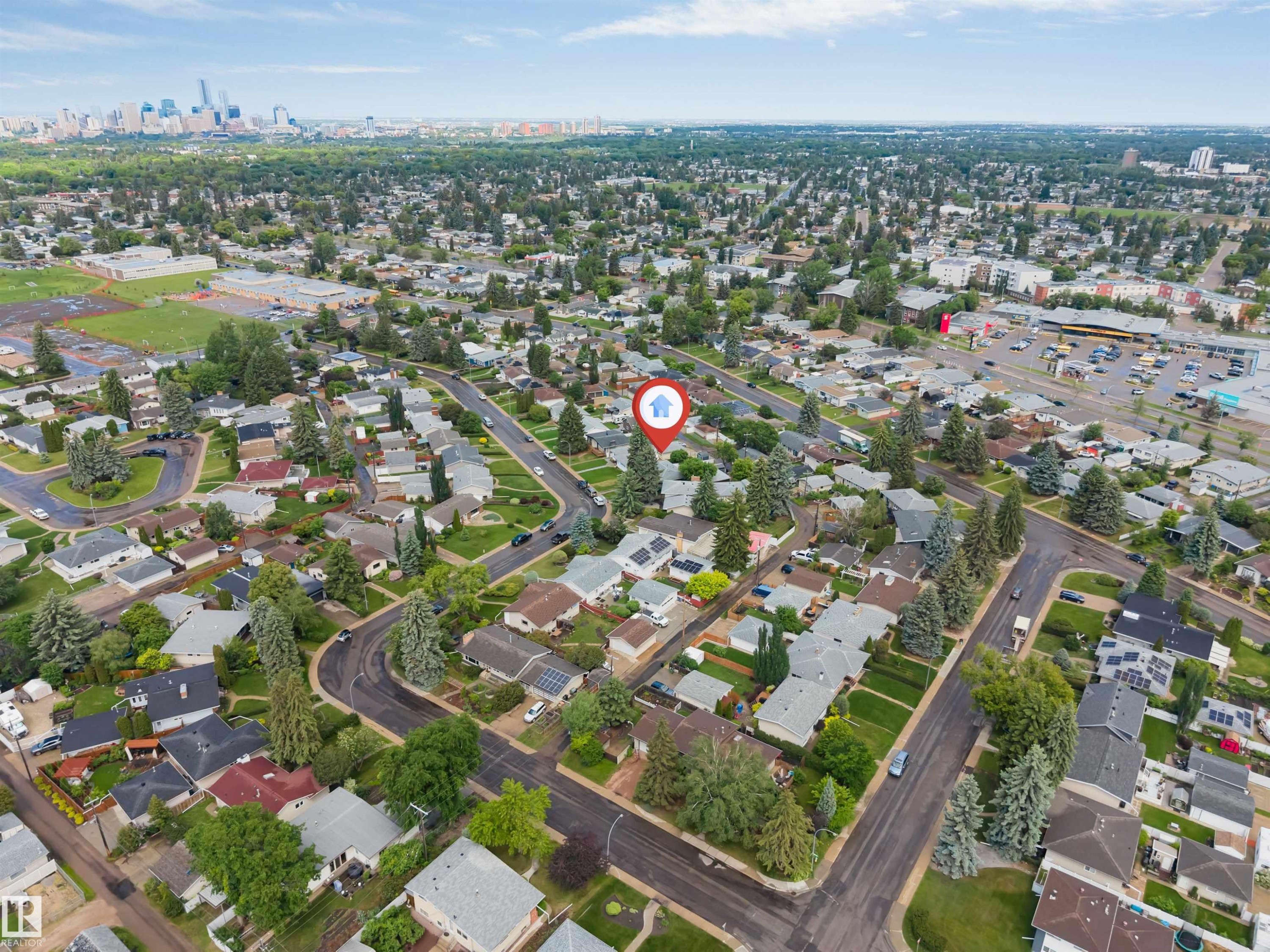 Aerial perspective showcasing a residential neighborhood with a distant cityscape - 6404 88 Avenue, Edmonton, AB