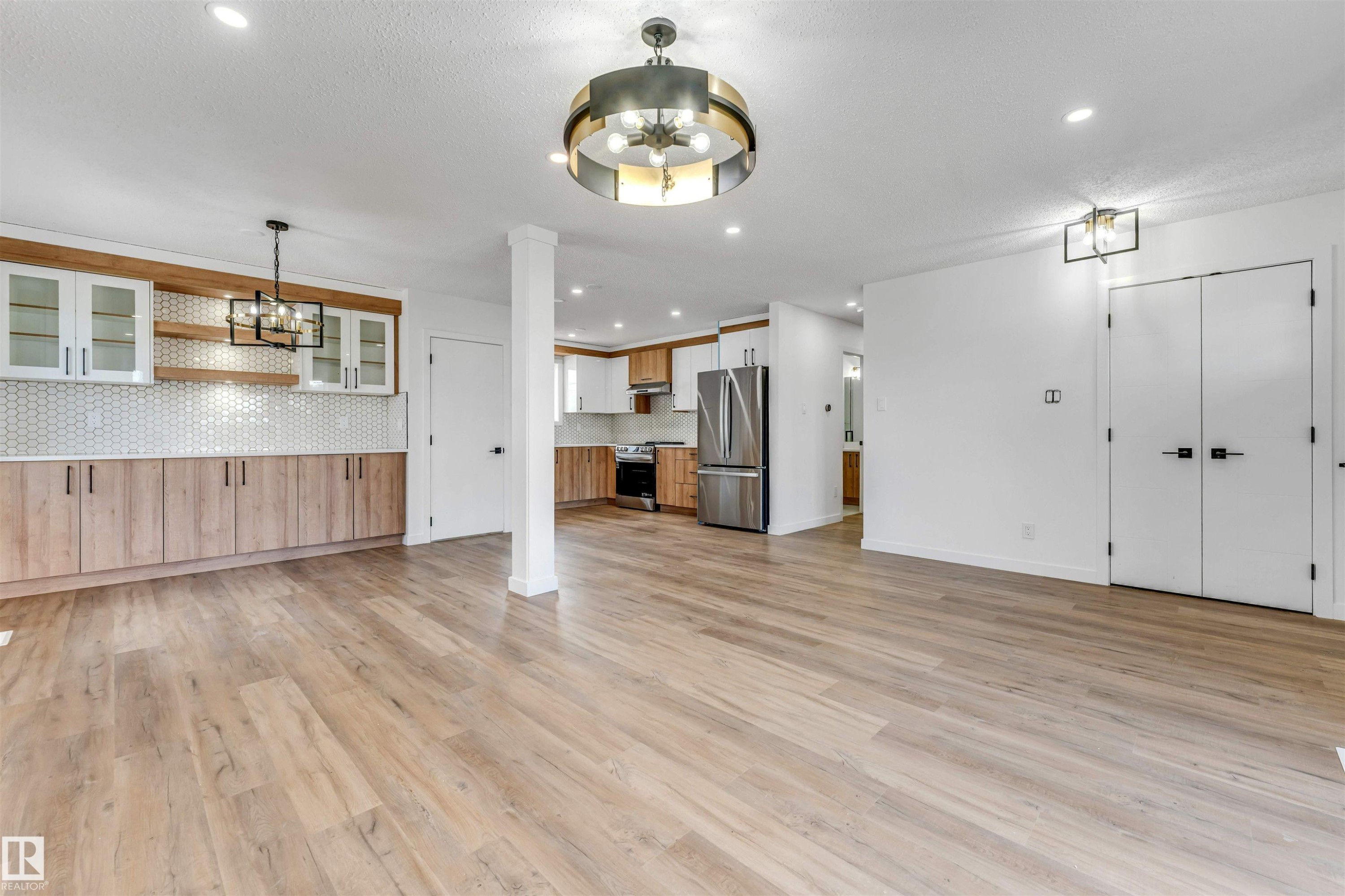 Open-concept living area with light wood-finish flooring - 6404 88 Avenue, Edmonton, AB