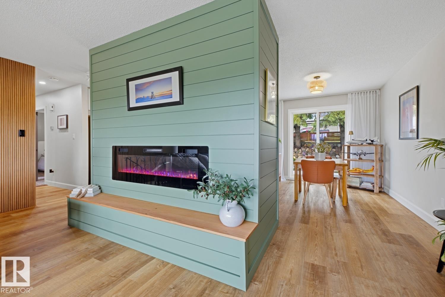 Feature wall with shiplap-style paneling and an integrated fireplace - 3504 102 Avenue, Edmonton, AB
