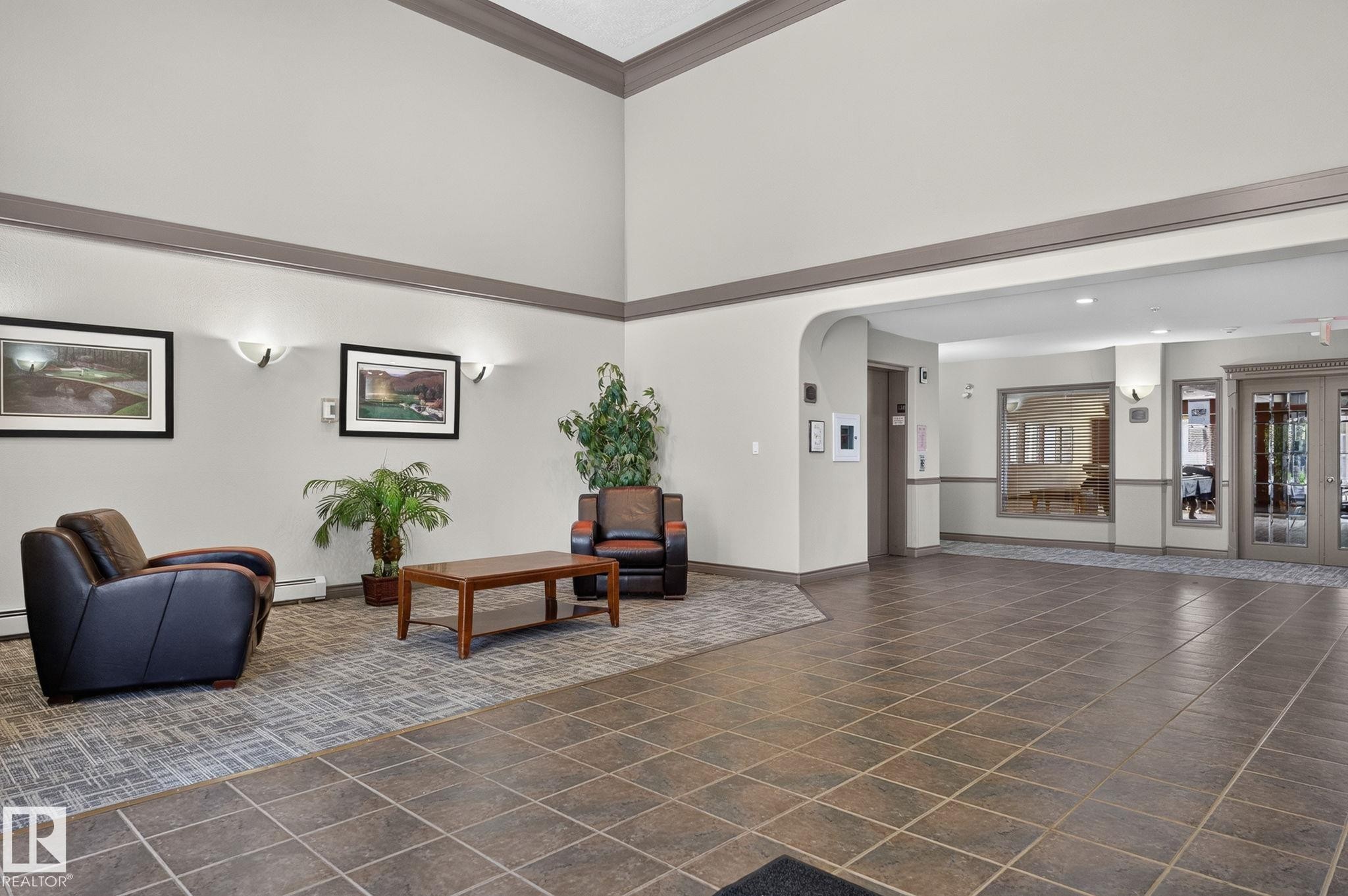 Spacious foyer featuring a neutral color palette with high ceilings and crown molding - 122 279 Suder Greens Drive, Edmonton, AB