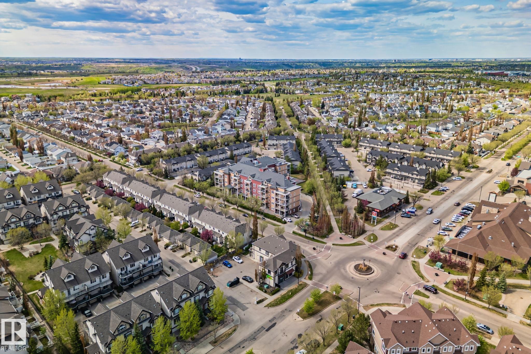 Aerial perspective showcasing a diverse residential area with single-family homes, townhouses, and multi-story apartment buildings - 209 5280 Terwillegar Boulevard, Edmonton, AB - Outdoor With View