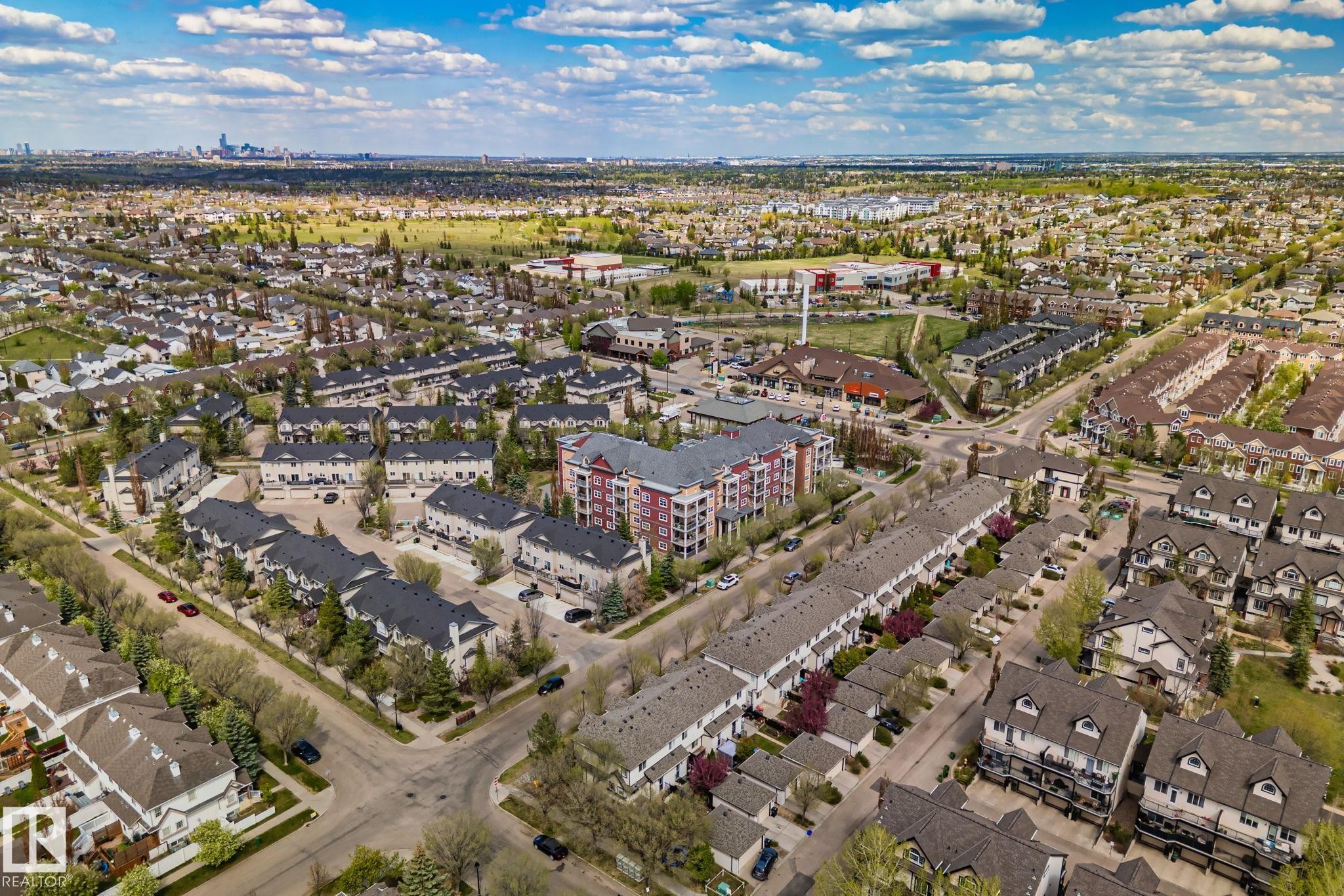 Expansive aerial capturing a vibrant urban landscape with diverse residential architecture and verdant green spaces - 209 5280 Terwillegar Boulevard, Edmonton, AB - Outdoor With View