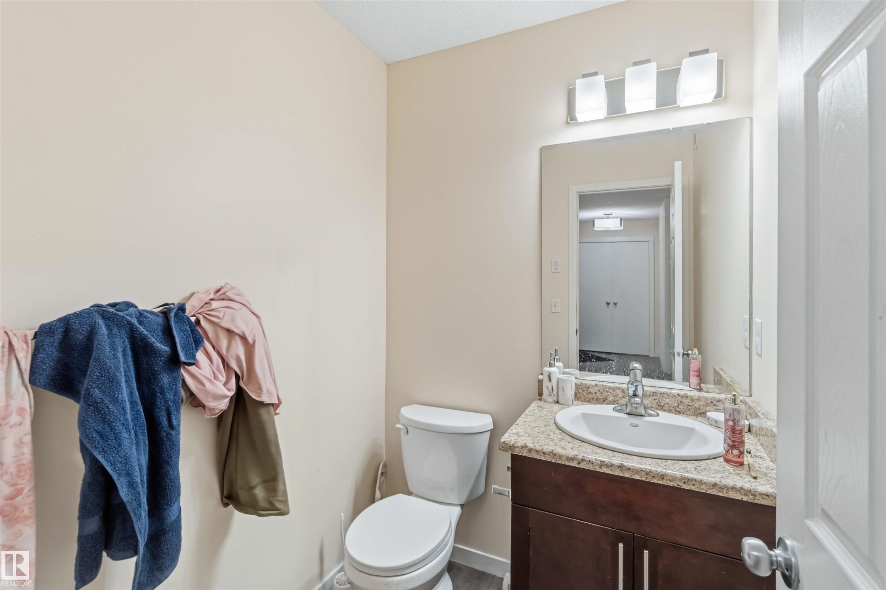 Bathroom featuring a dark wood-finish vanity with a - 5120 19 Avenue, Edmonton, AB