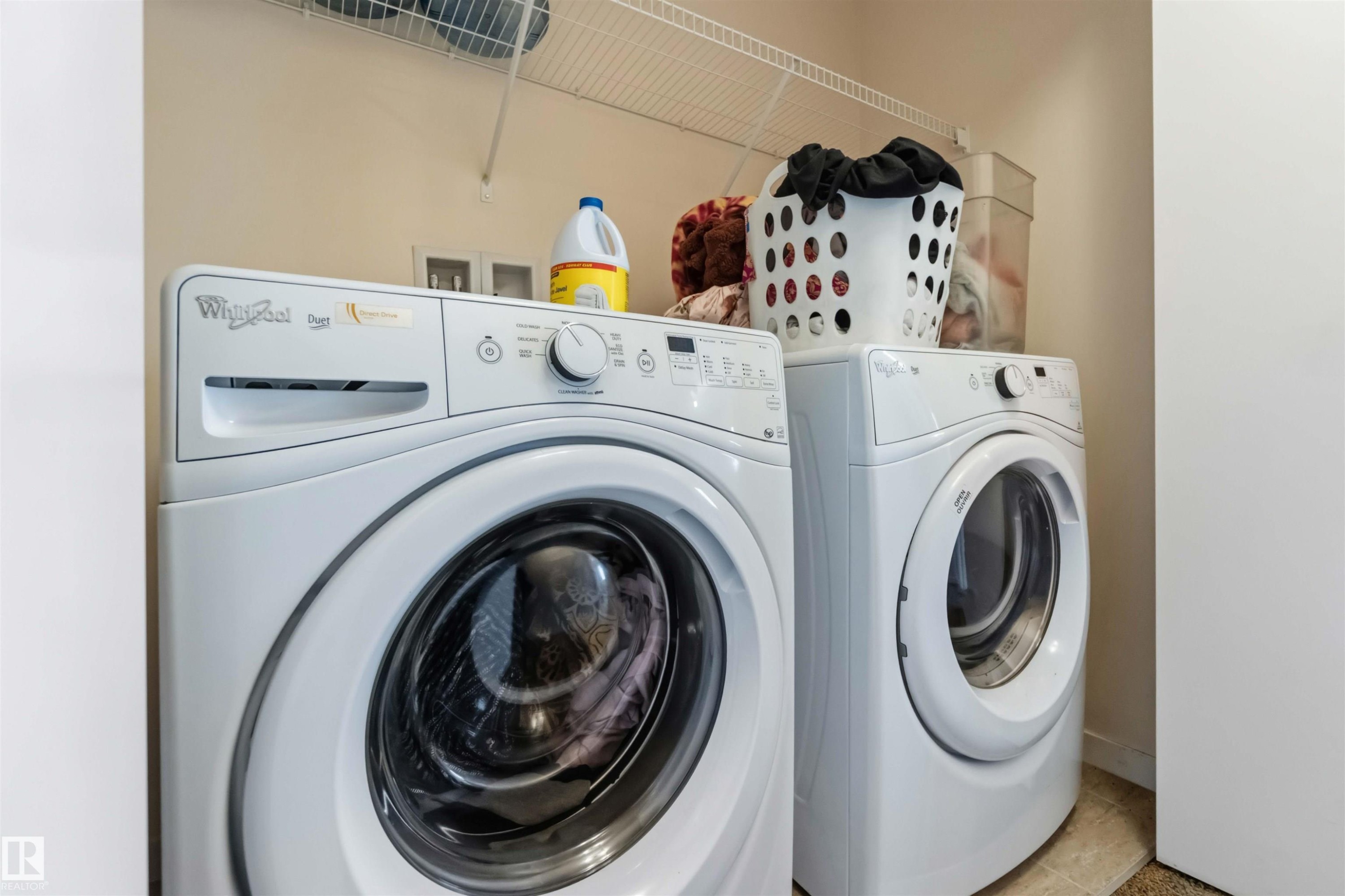 Dedicated laundry area featuring a front-load washer and dryer set - 5120 19 Avenue, Edmonton, AB