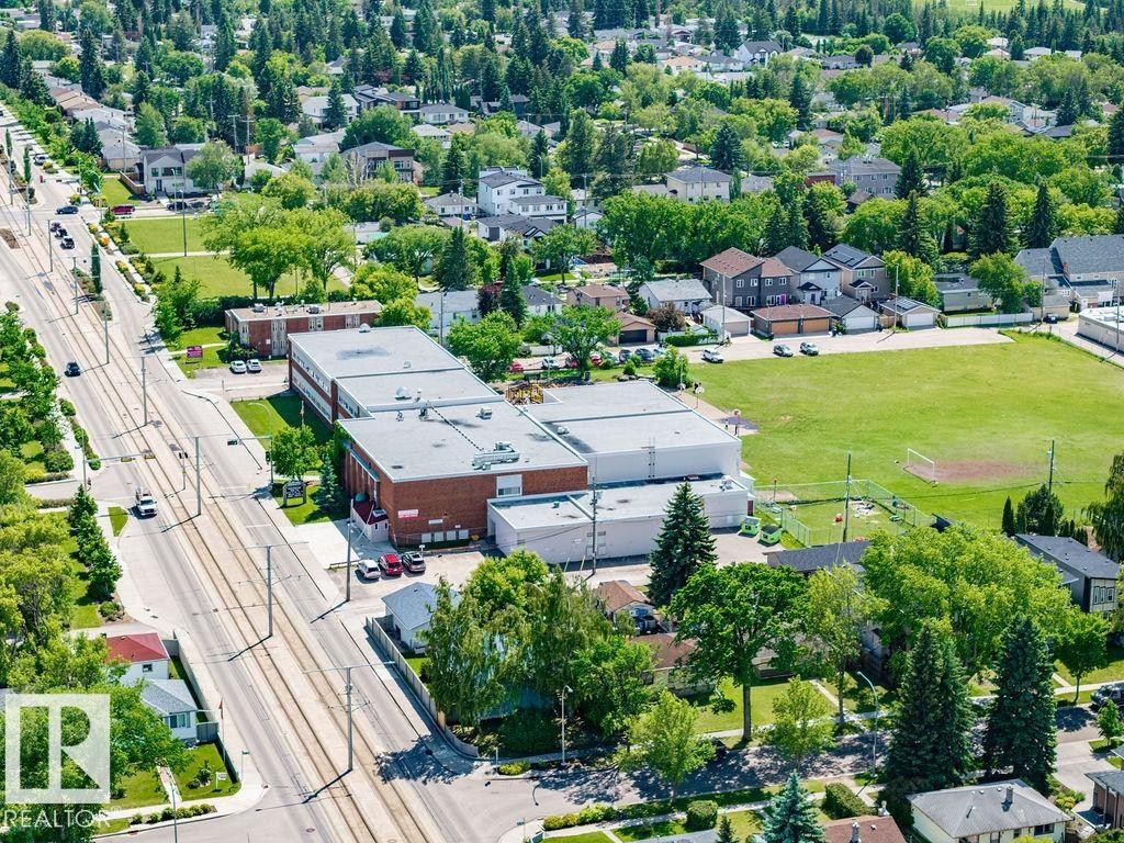 Aerial perspective showcasing a residential area with extensive tree coverage - 8318 80 Avenue Nw, Edmonton, AB - Outdoor