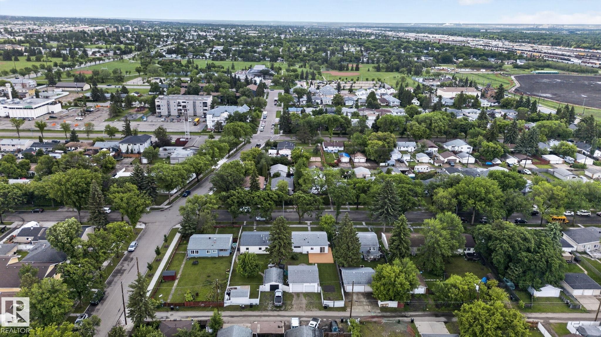 Aerial perspective showcasing a residential neighborhood with numerous mature trees - 12952 114 Street Nw, Edmonton, AB