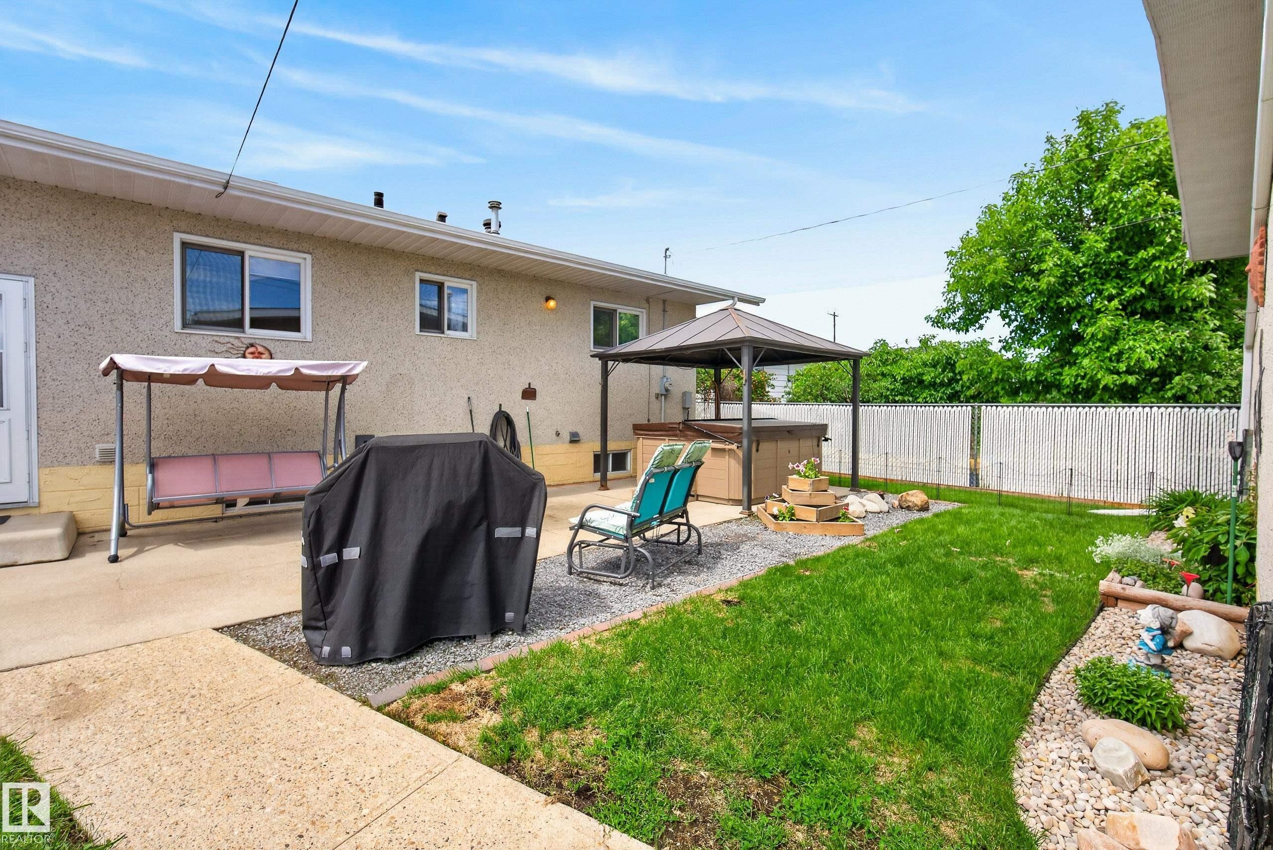 Concrete patio featuring an overhead gazebo structure and direct access to the interior - 10935 152 Street, Edmonton, AB
