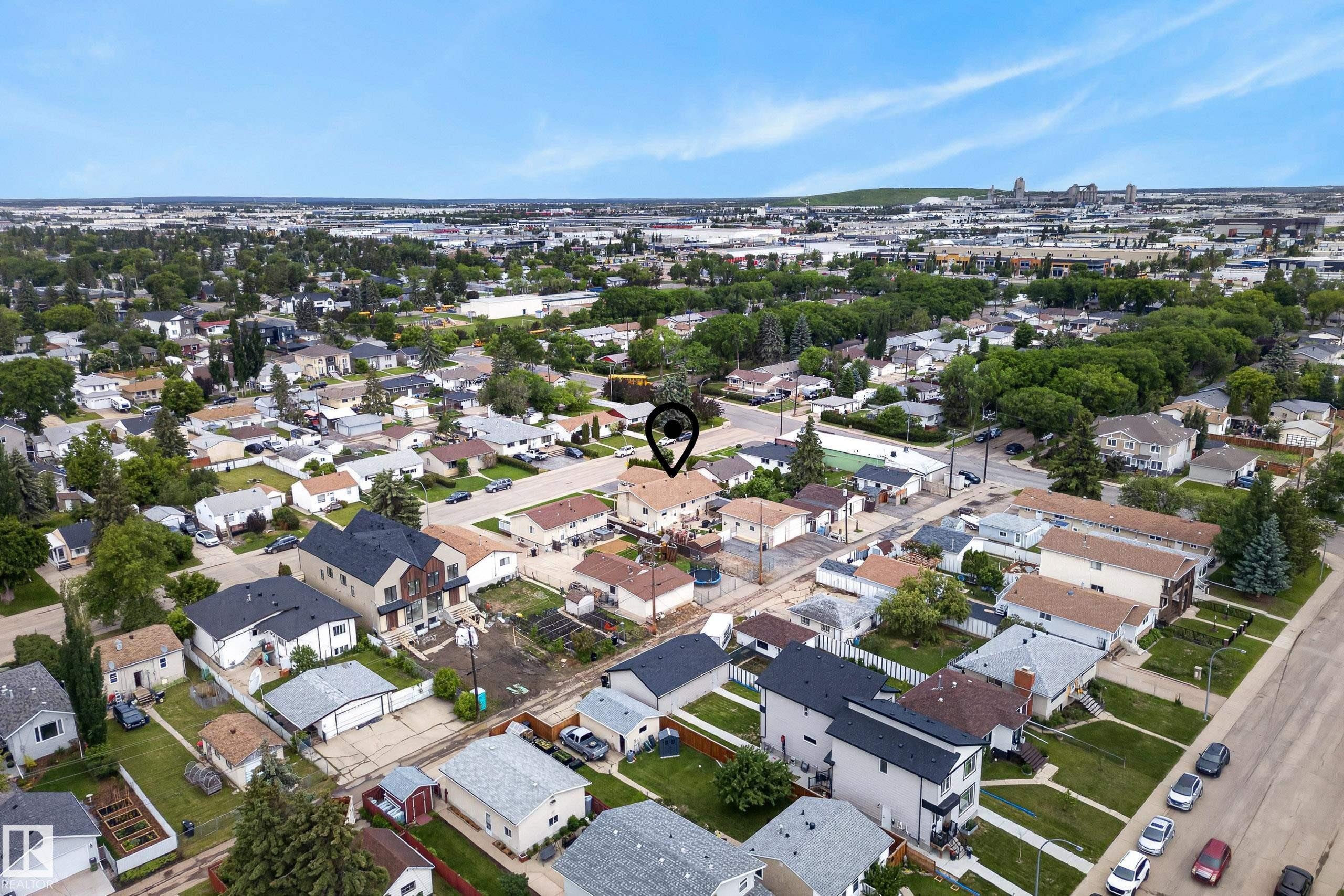 Aerial view showcasing a residential neighborhood with a mix of single-family homes and multi-story residences - 10935 152 Street, Edmonton, AB