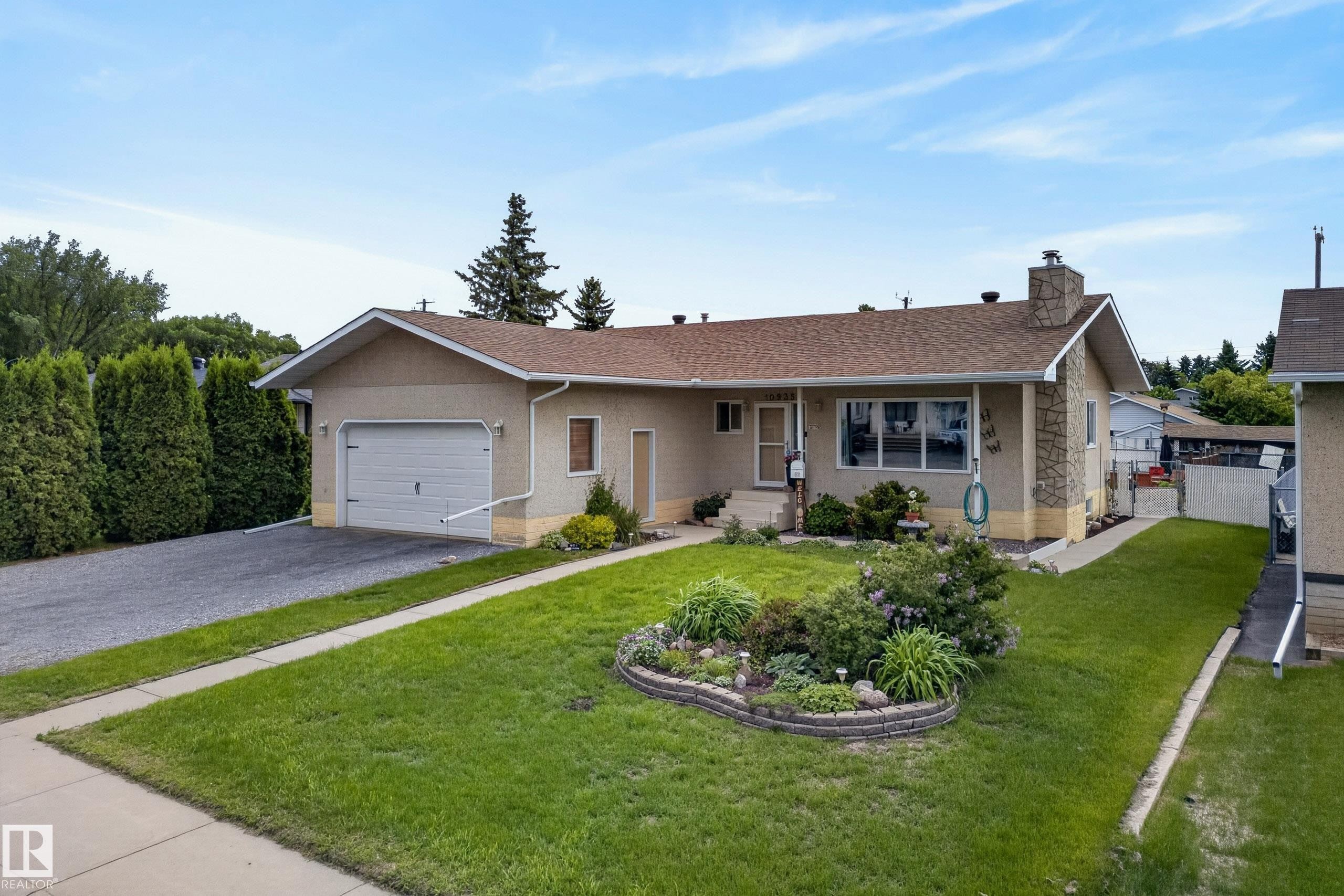 Ranch-style residence featuring a single-car garage with a paved driveway - 10935 152 Street, Edmonton, AB