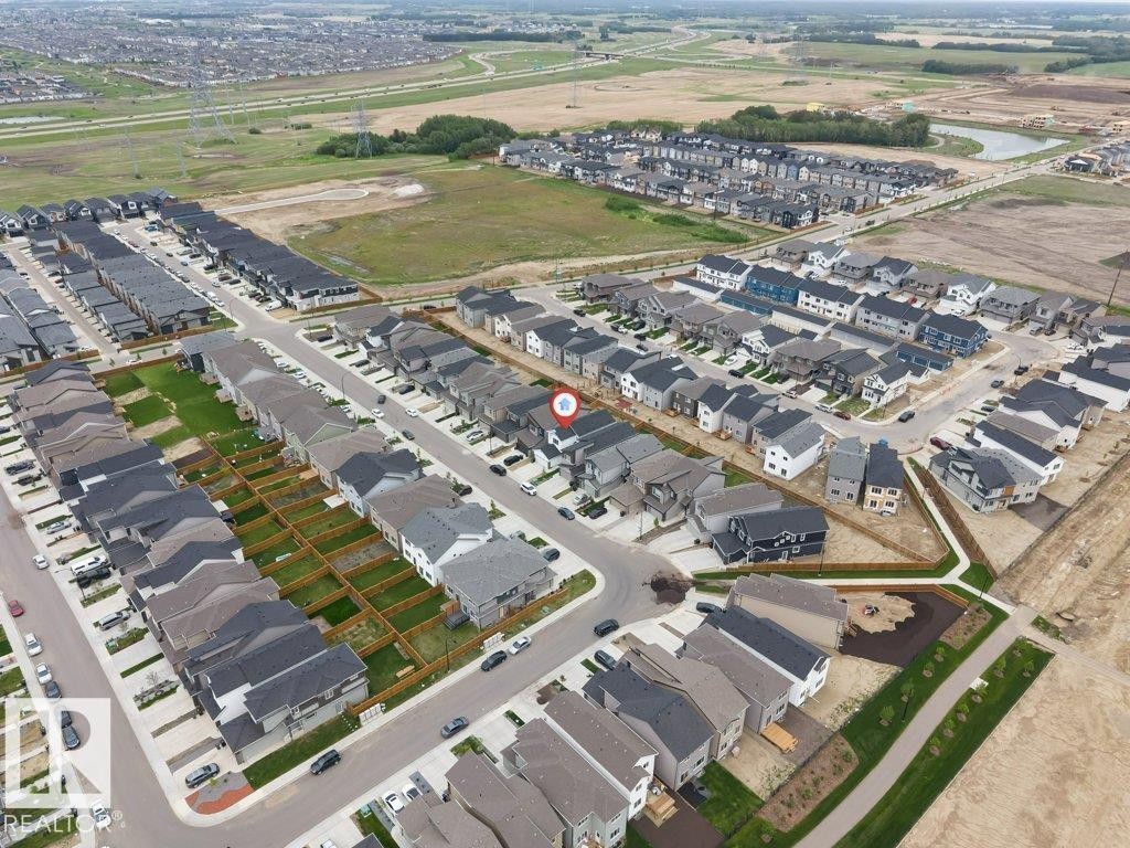 New construction community featuring varied architectural styles, a network of residential streets, and individual backyard spaces - 423 28 Street, Edmonton, AB