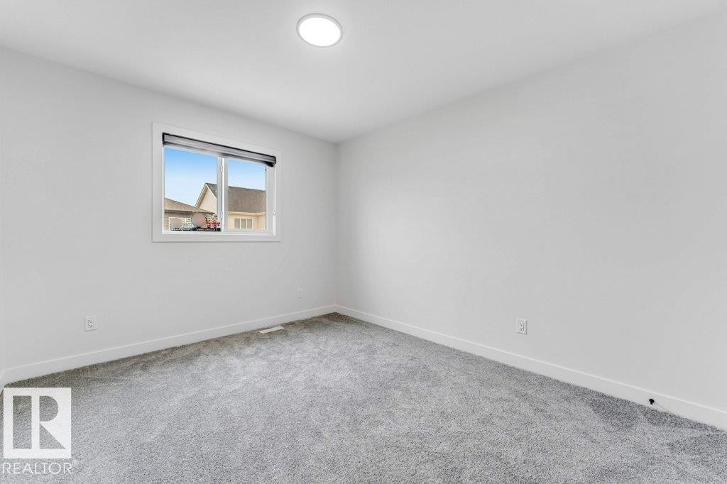 Room featuring light gray carpeting, white walls, and a recessed ceiling light - 423 28 Street, Edmonton, AB
