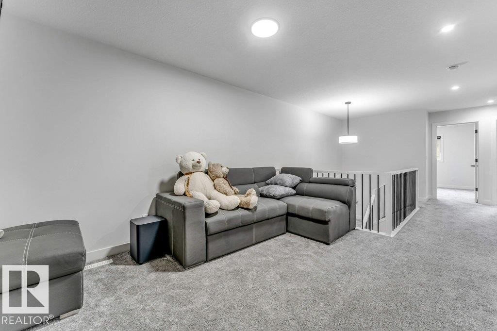 Carpeted bonus room with recessed lighting and a modern pendant light fixture - 423 28 Street, Edmonton, AB