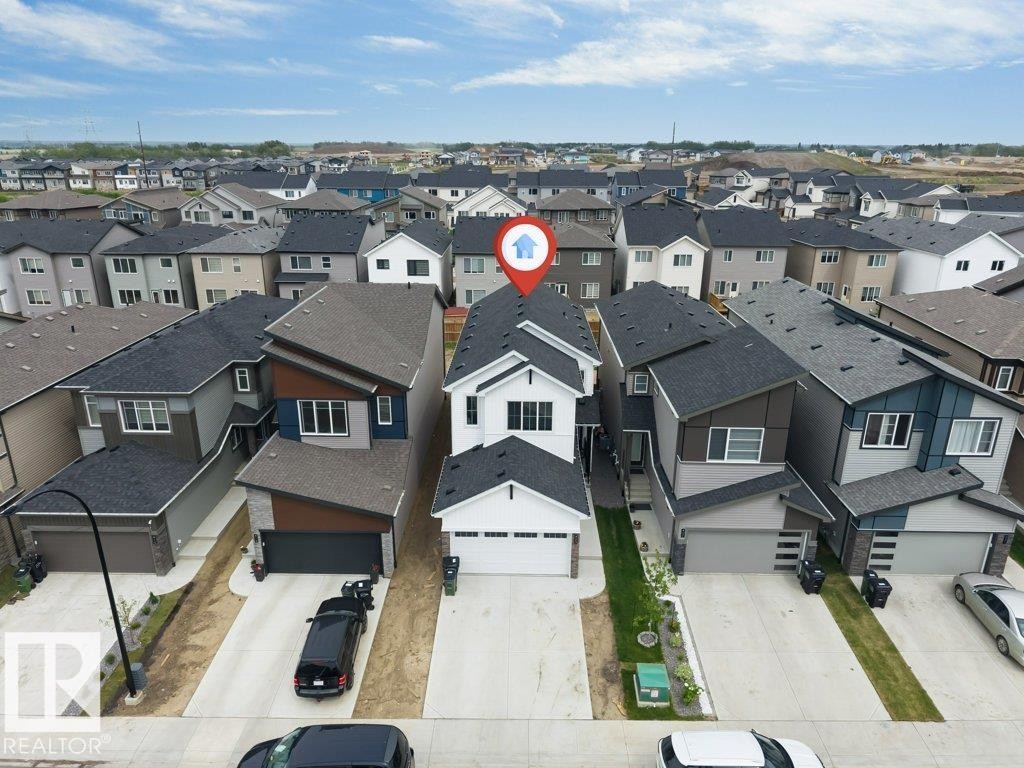 Contemporary multi-story residence featuring a white facade and dark trim - 423 28 Street, Edmonton, AB
