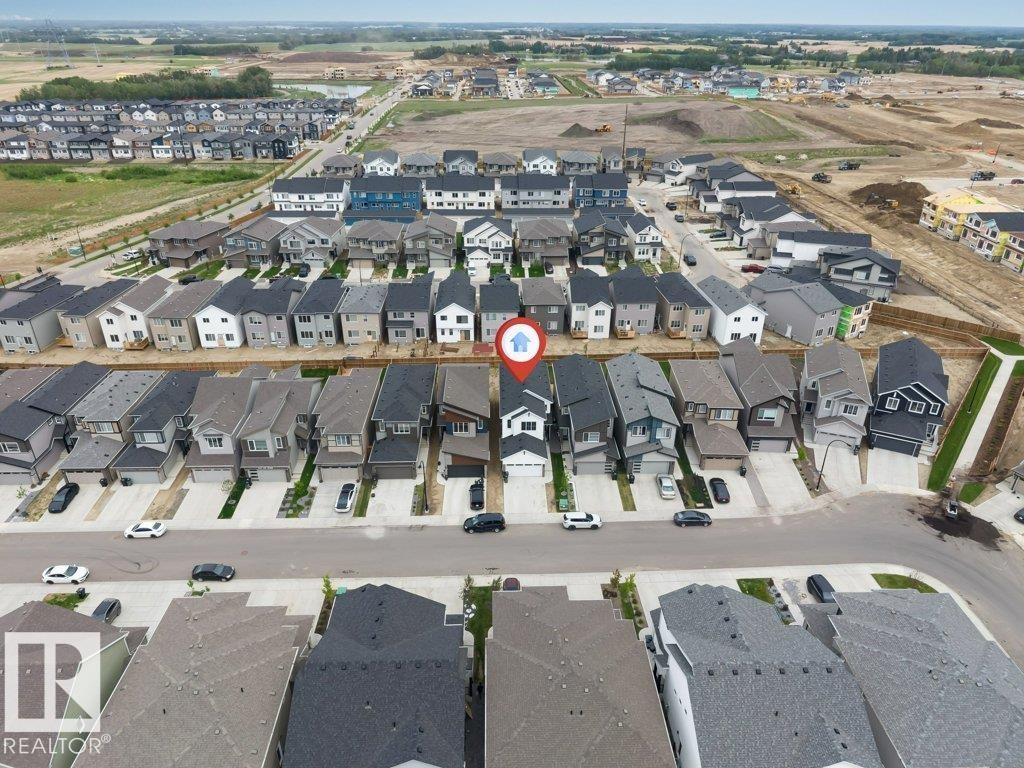 Aerial perspective showcasing a developed residential street with uniform detached homes - 423 28 Street, Edmonton, AB