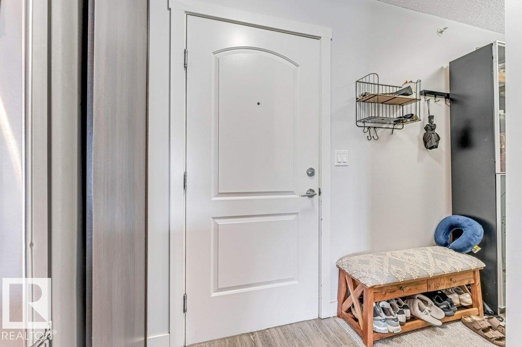 White paneled entry door with an arched top panel - 401 667 Watt Boulevard, Edmonton, AB