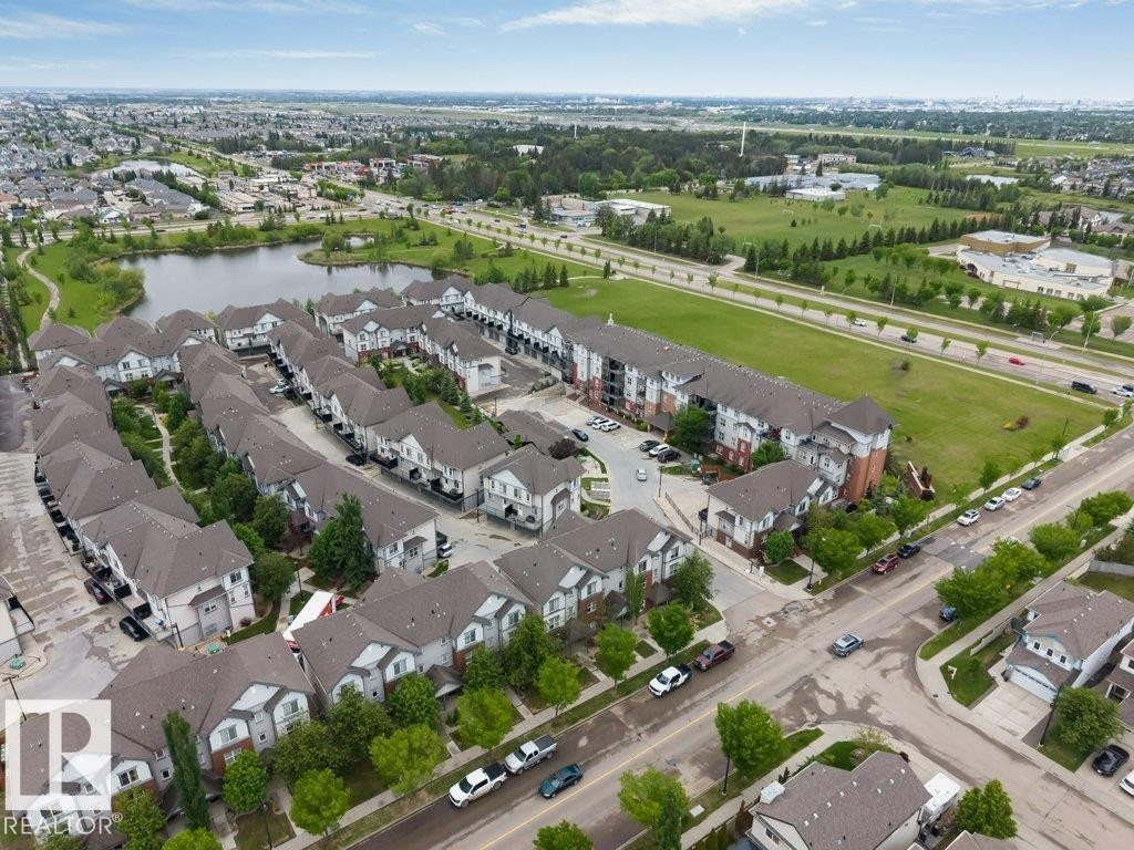 Aerial perspective showcasing a residential development with townhomes and multi-story buildings - 401 667 Watt Boulevard, Edmonton, AB